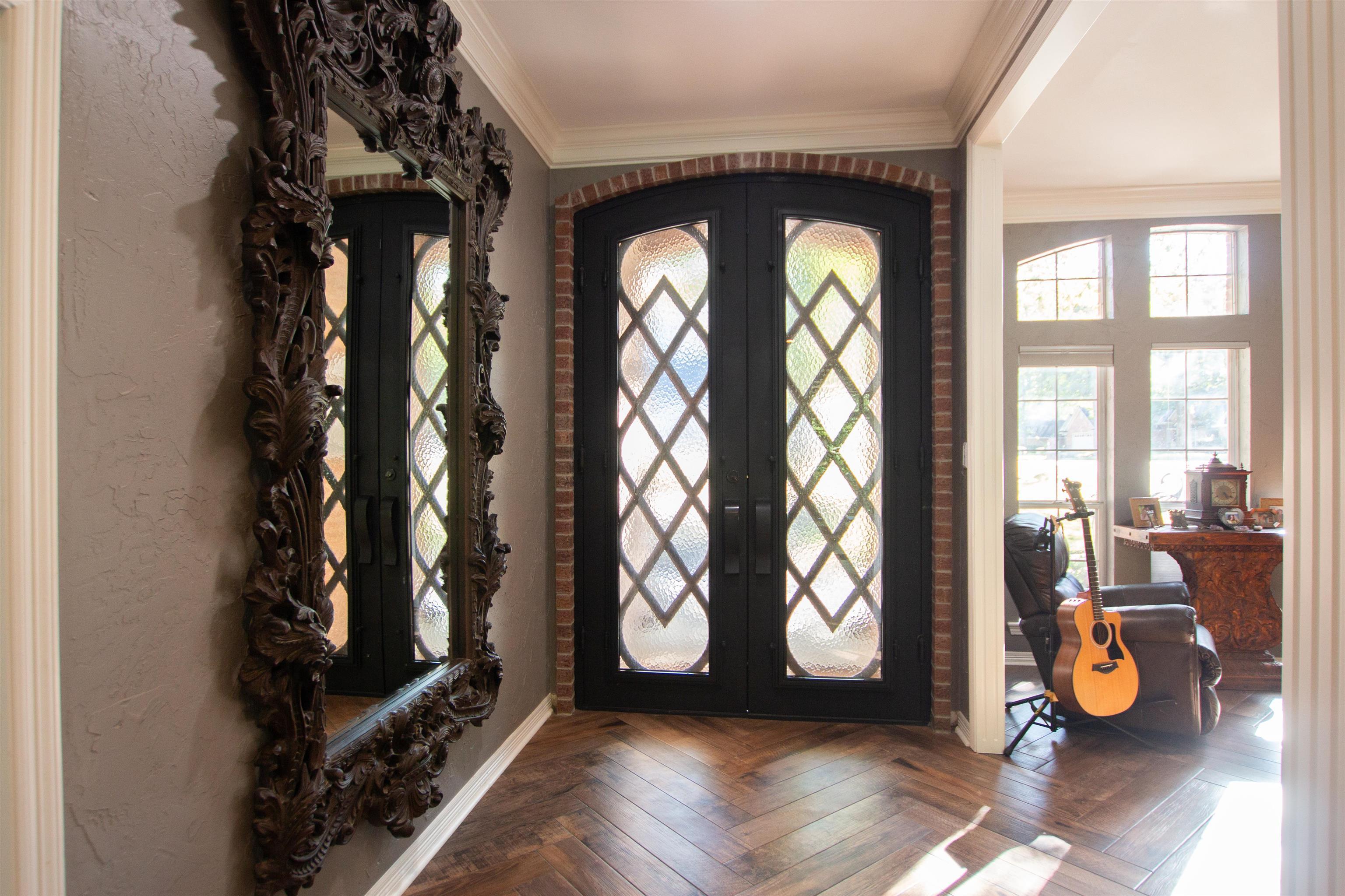 Image 2: Entrance foyer with french doors, crown molding, and arched walkways, Entrance Foyer