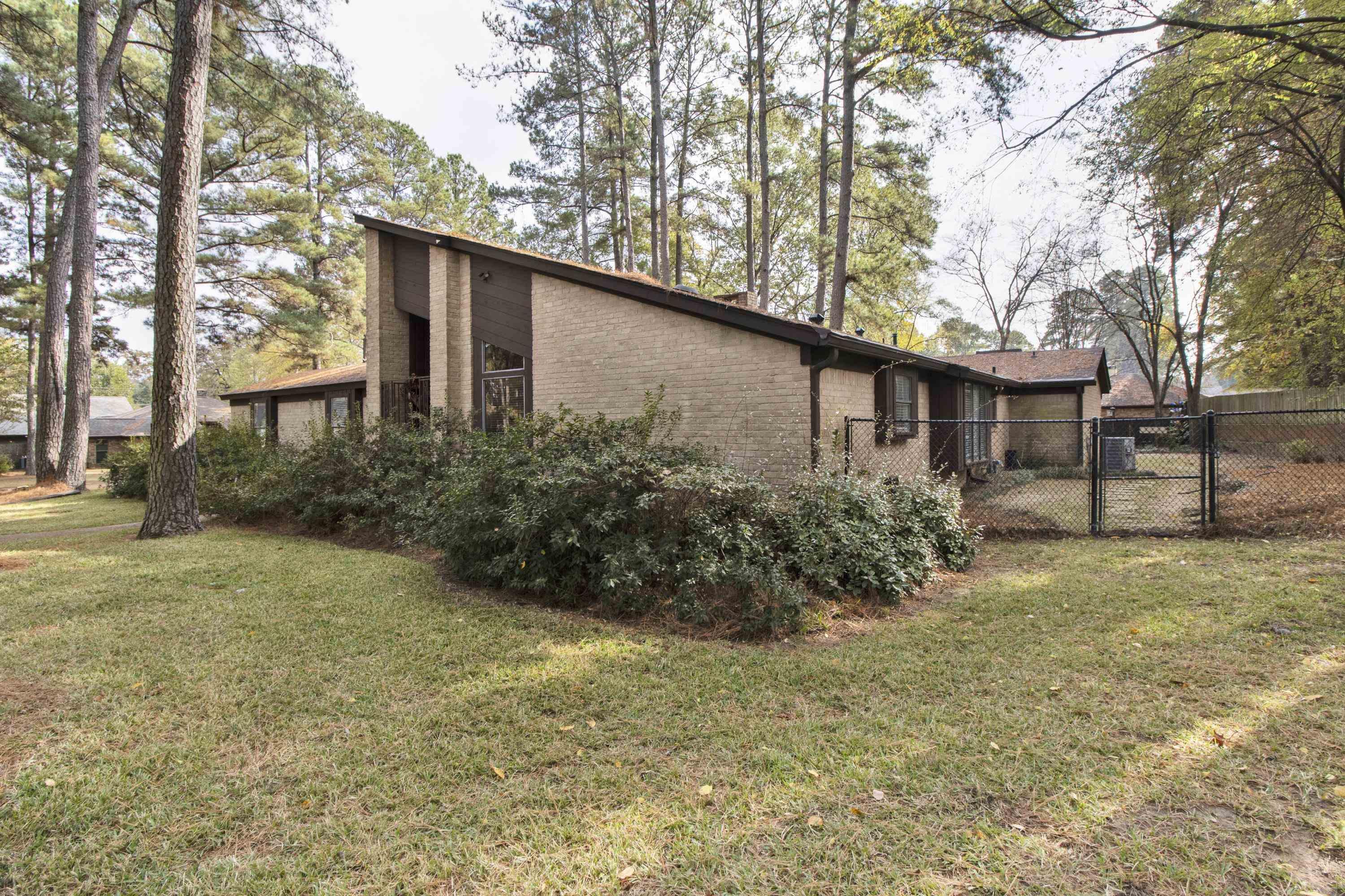 Image 1: View of side of property featuring brick siding, Side Of Structure