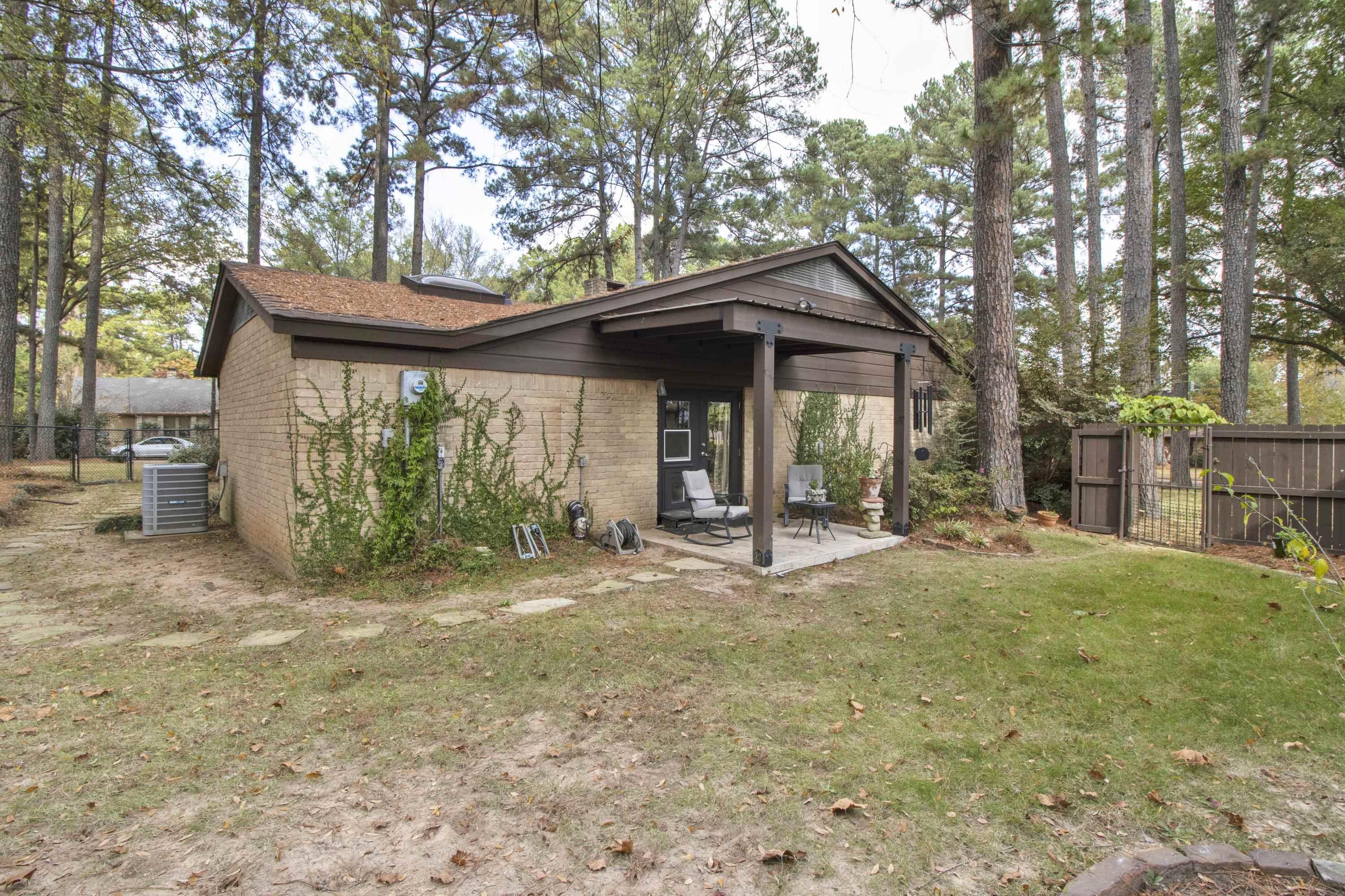 Image 2: Rear view of property featuring a patio and brick siding, Back Of Structure