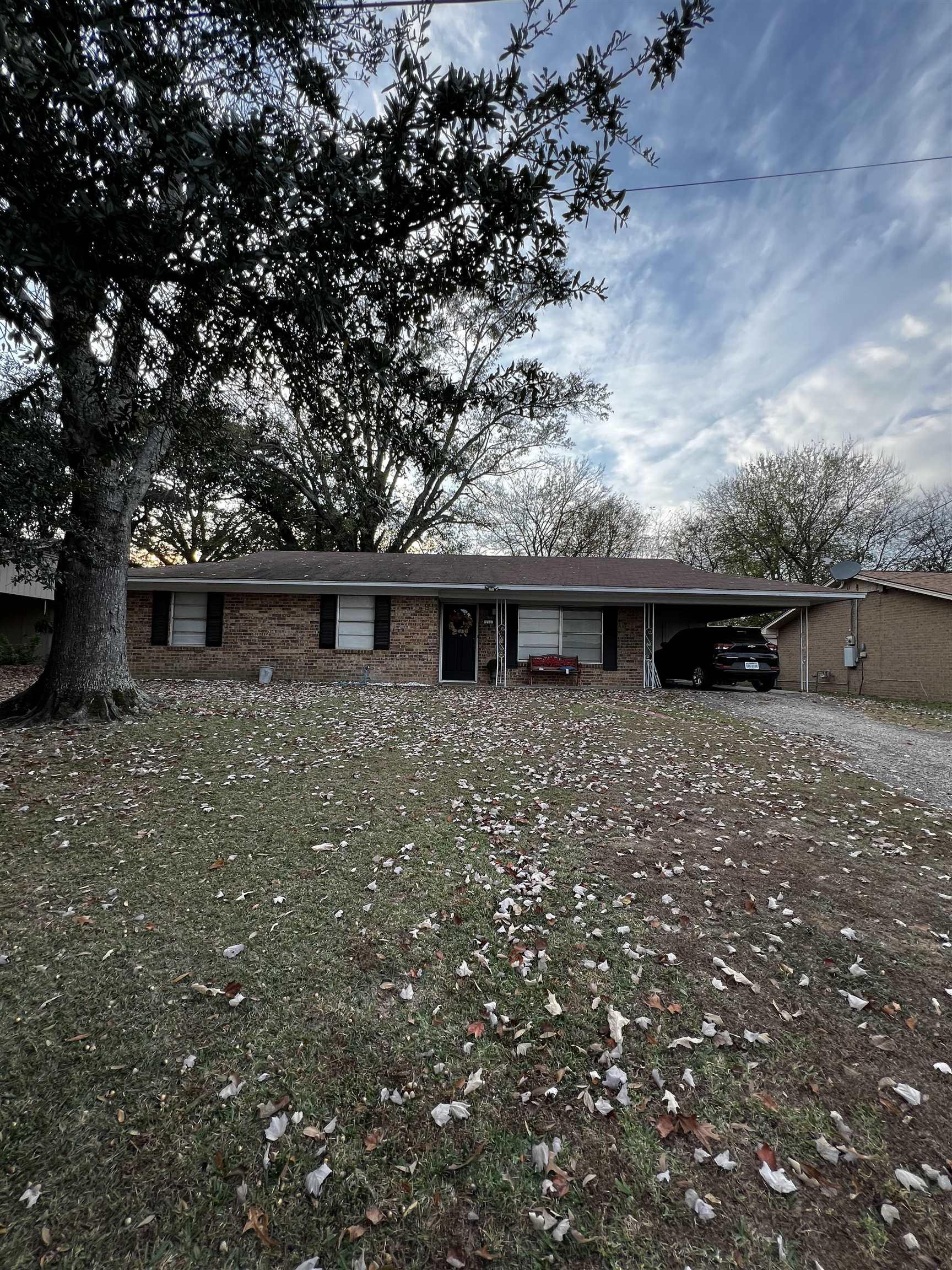Image 0: Ranch-style home featuring brick siding, an attached carport, and driveway, Front Of Structure