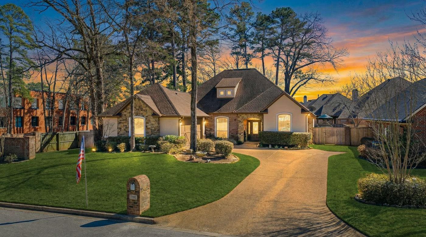 Image 0: French provincial home featuring concrete driveway, stone siding, and stucco siding, Front Of Structure