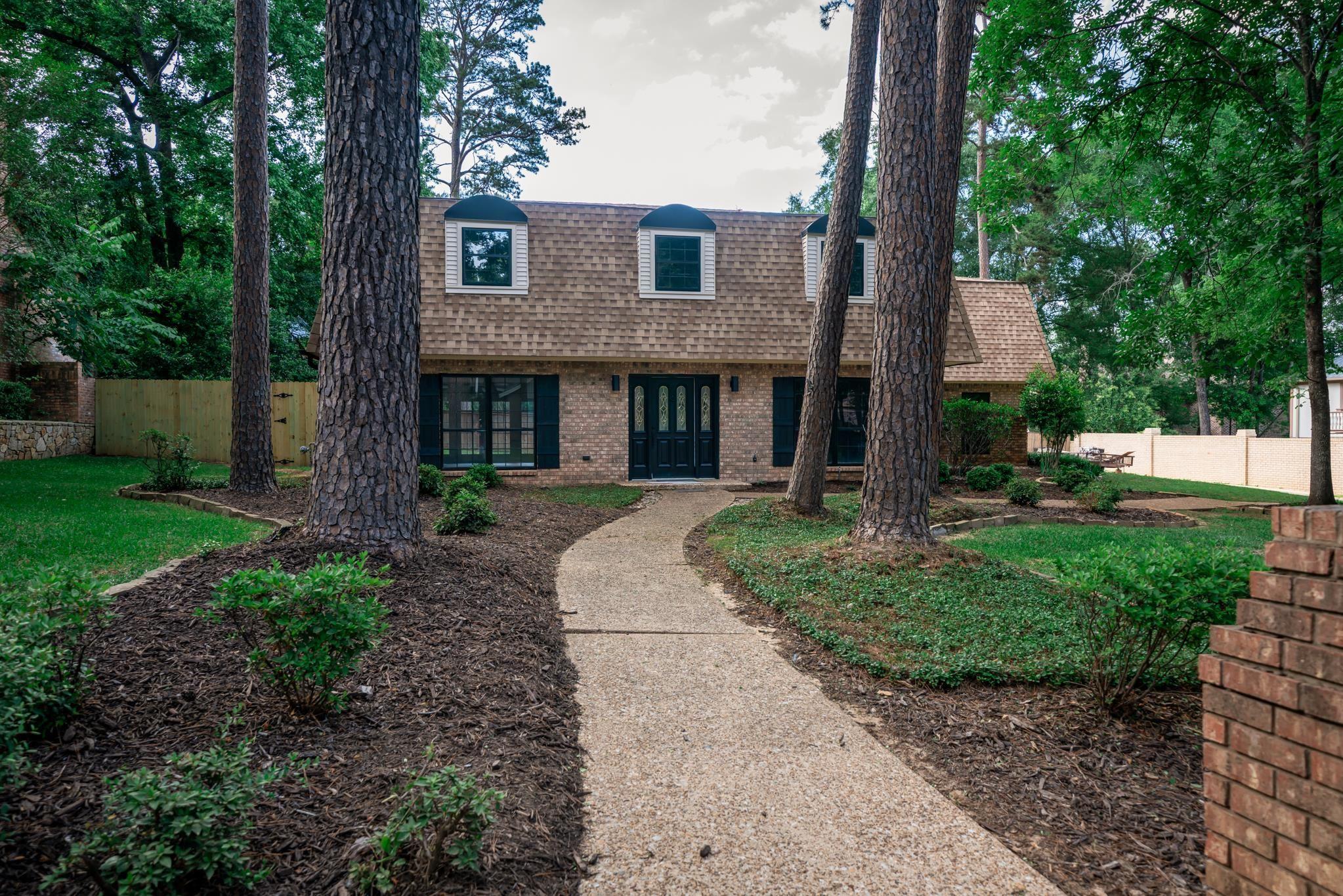 Image 2: Brick facade home featuring a light-colored shingle roof with three dormer windows, Front Of Structure