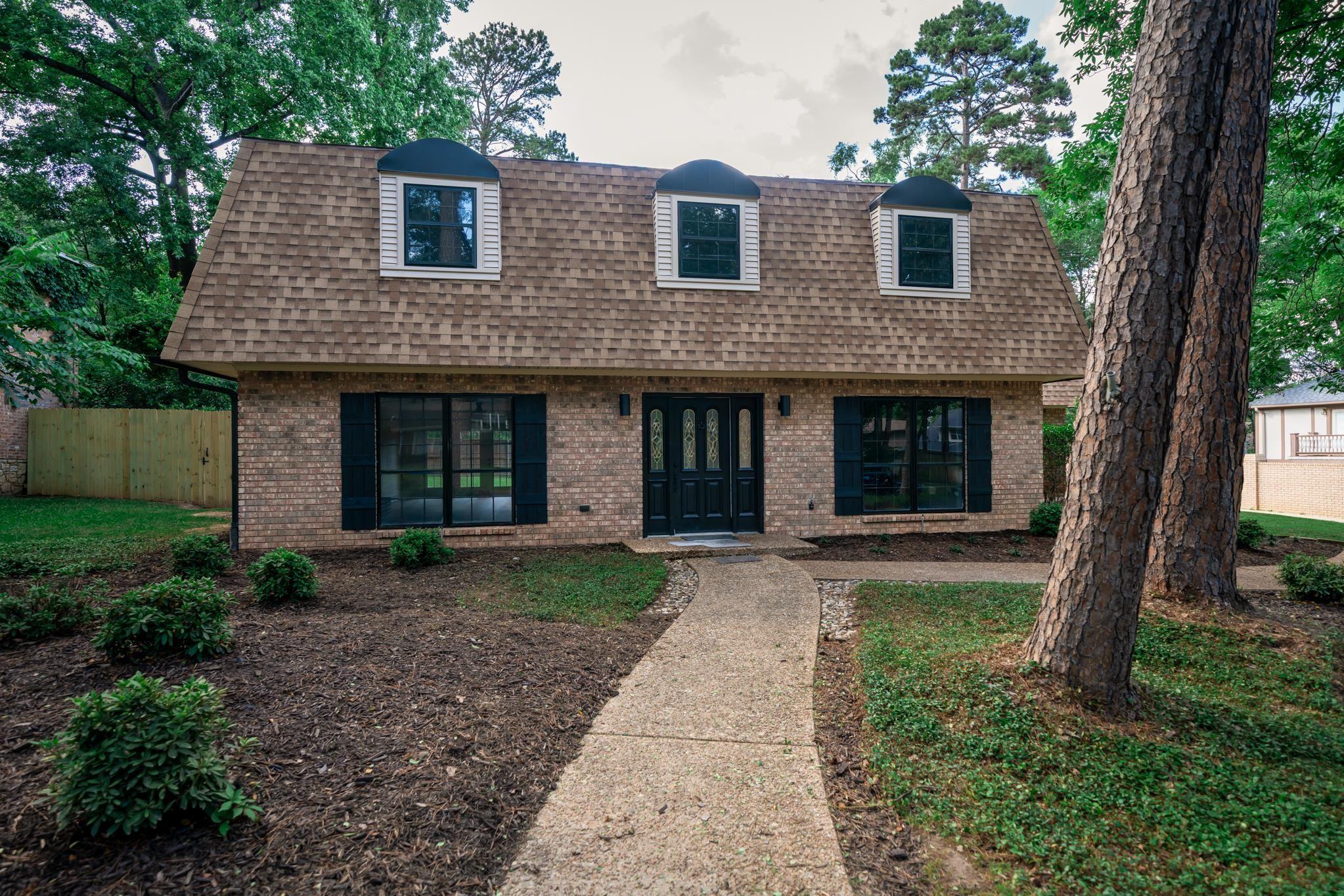 Image 3: Brick exterior featuring a gambrel roof and three dormer windows, Front Of Structure