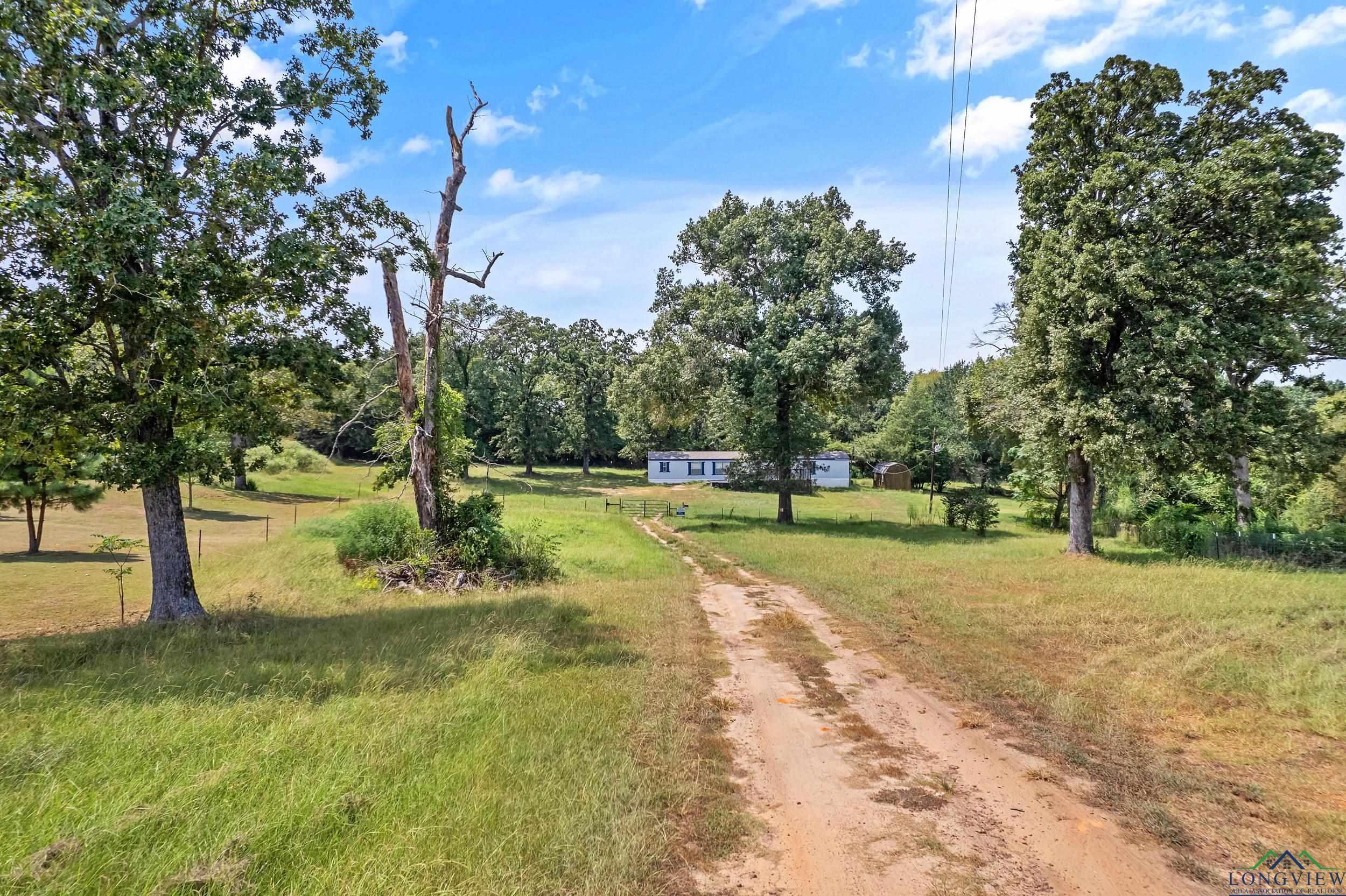 Image 0: View of dirt / gravel driveway, Community