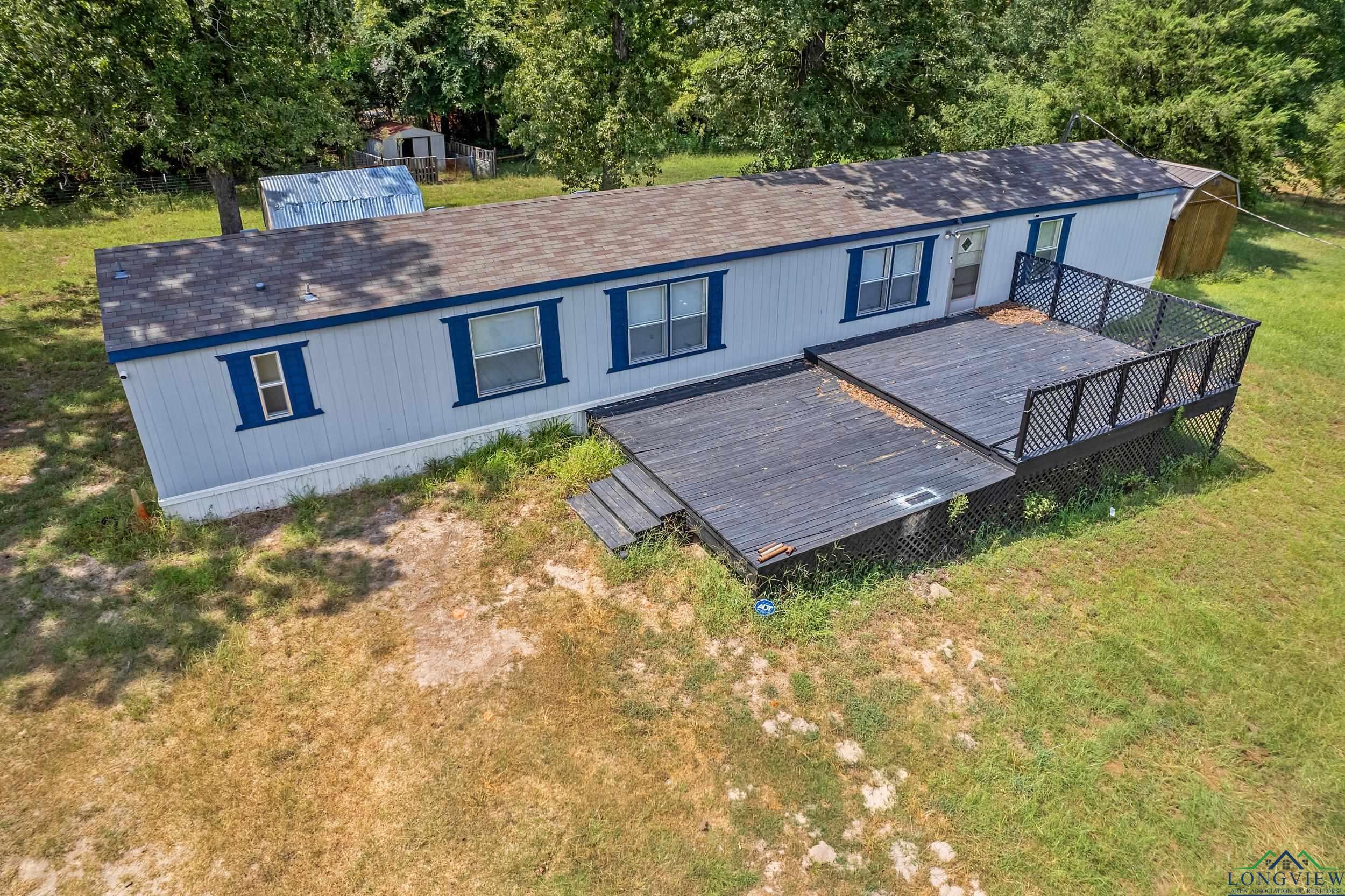 Image 2: Back of house with a lawn, roof with shingles, and a deck, Back Of Structure