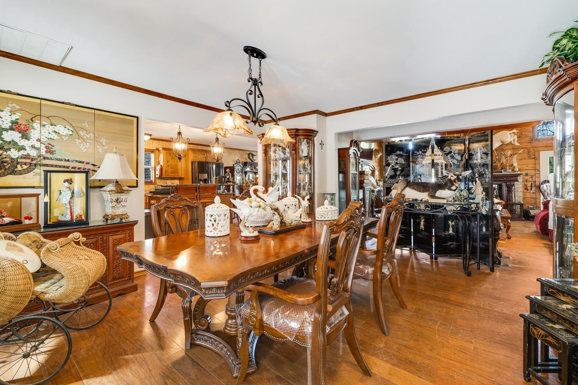 Image 3: Dining room with hardwood / wood-style floors, a chandelier, and ornamental molding, Dining Area