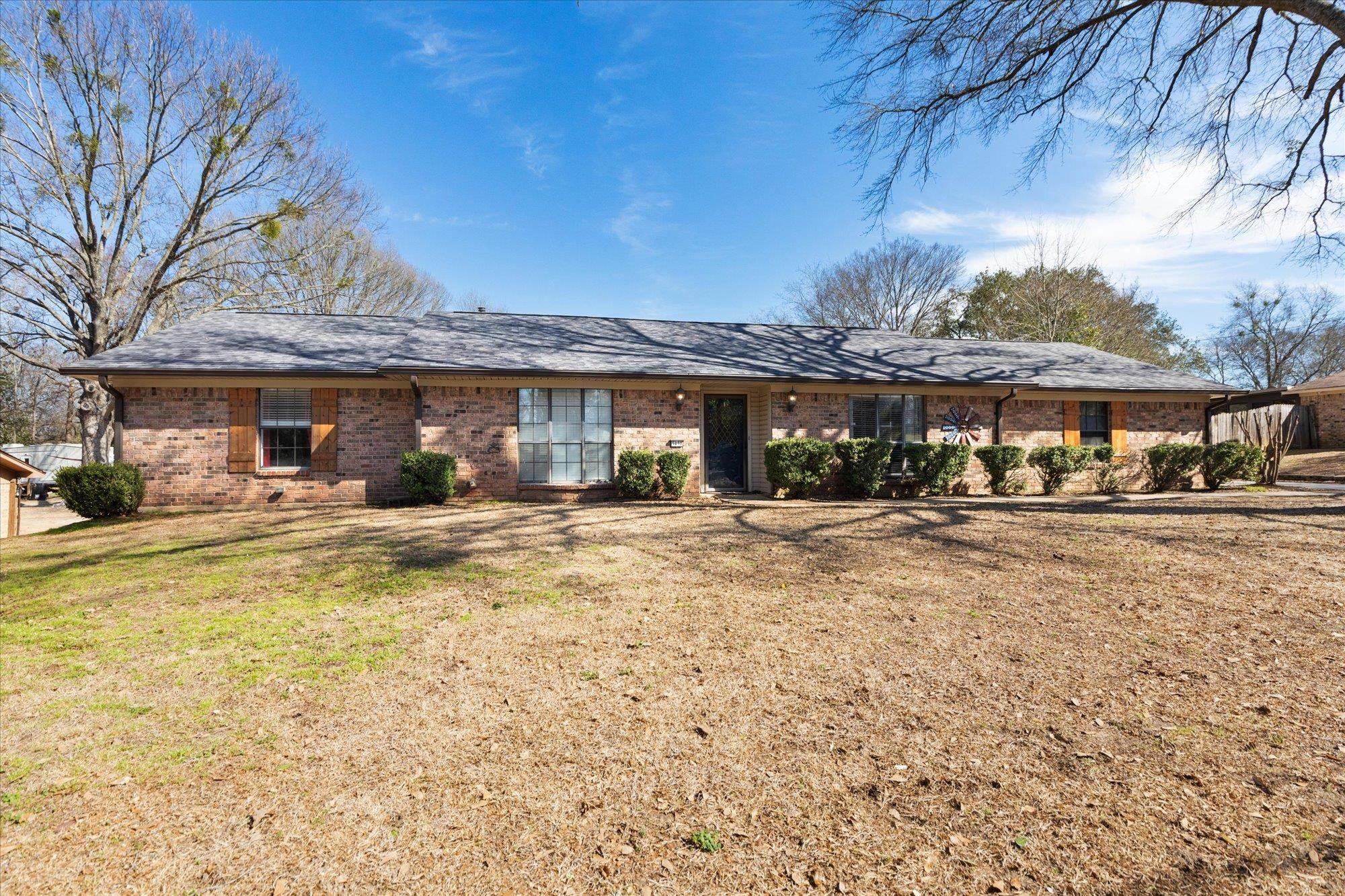 Image 1: Ranch-style home featuring brick siding and a front yard, Front Of Structure