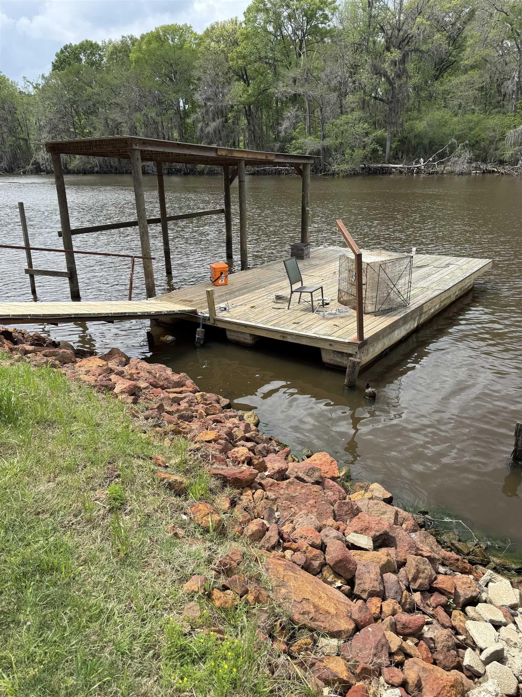 Image 2: Dock featuring a water view and a view of trees, Dock