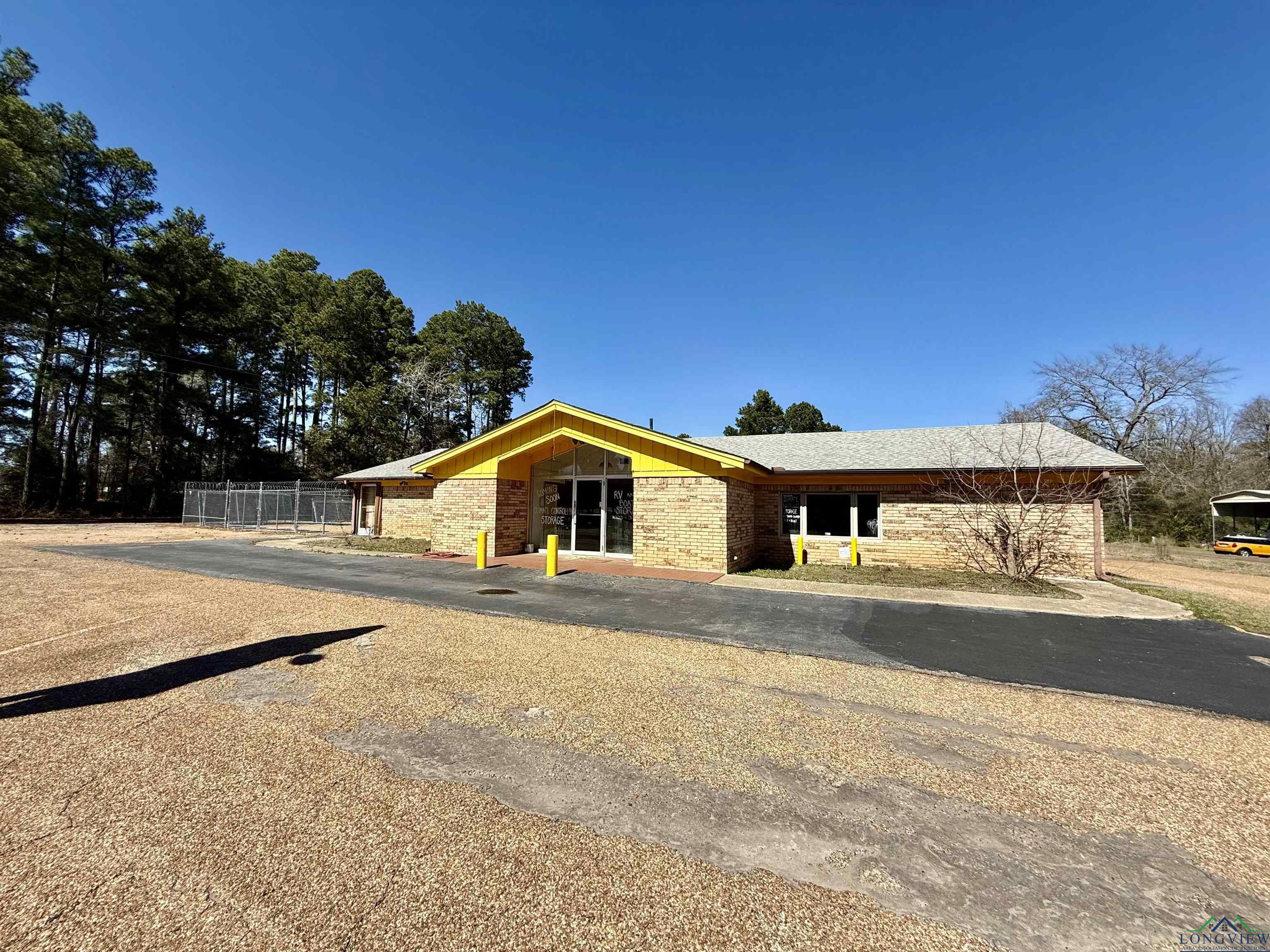 Image 0: View of front of home with brick siding and fence, Front Of Structure