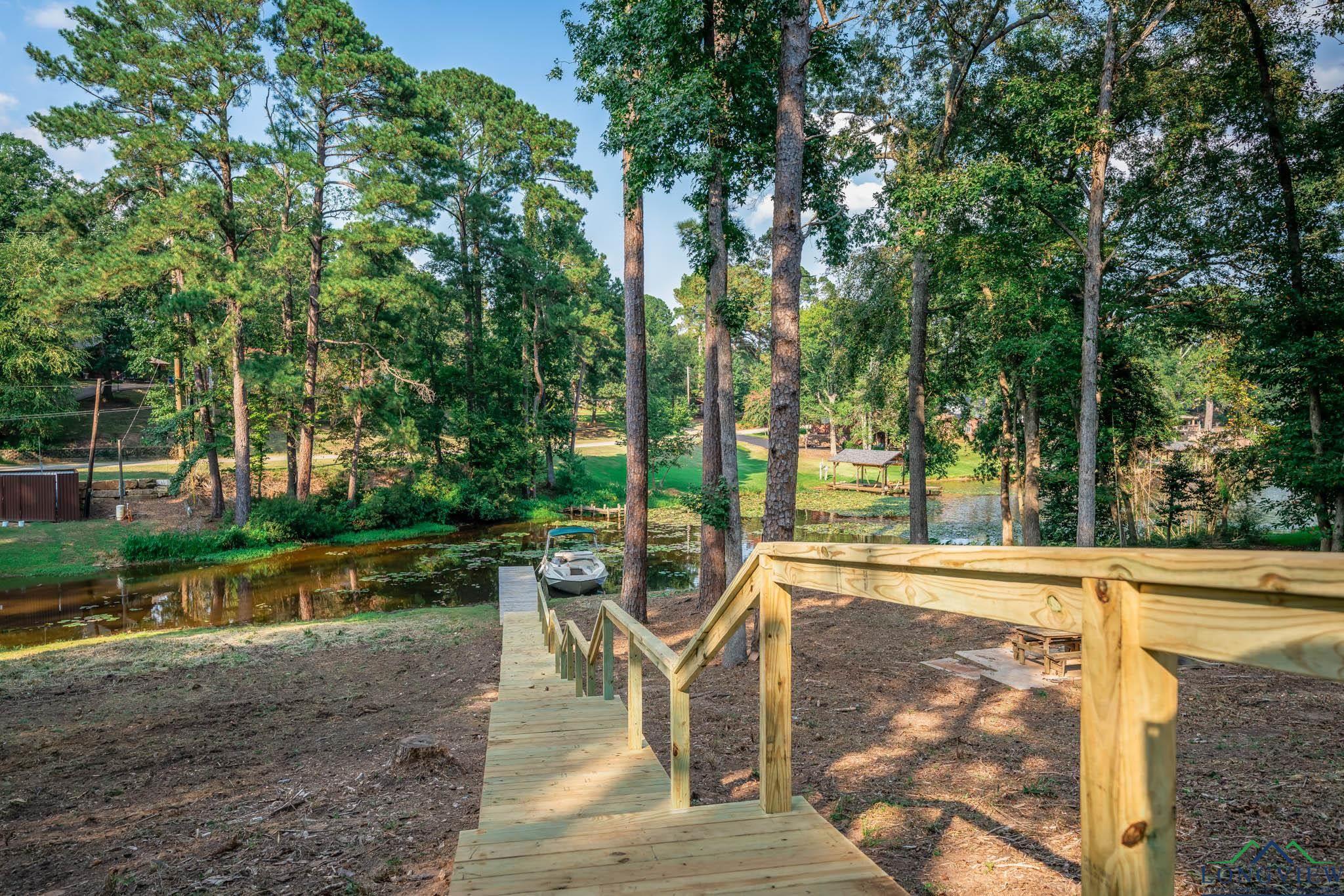 Image 4: Surrounding community featuring view of wooded area and a water view, Community
