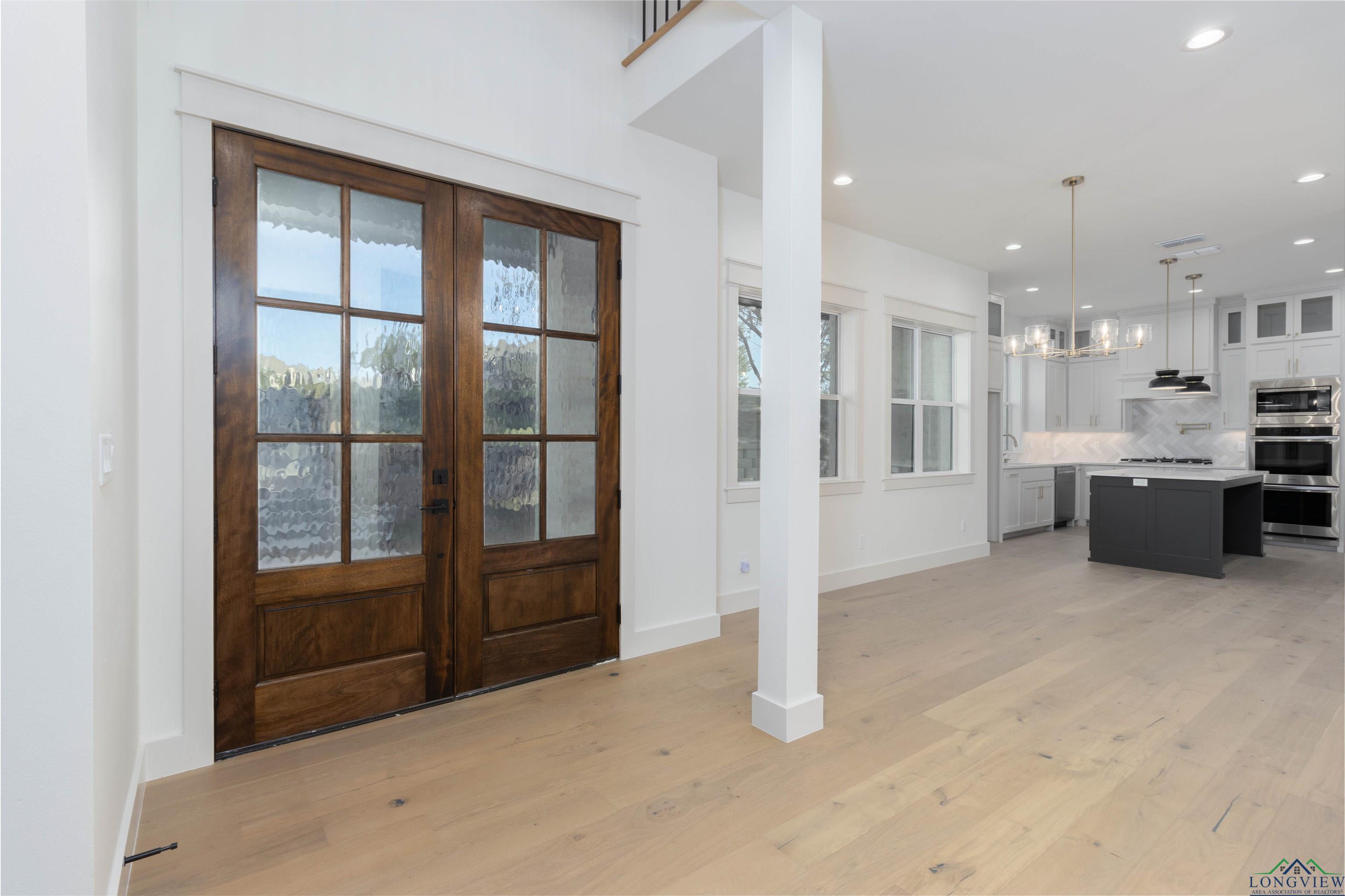 Image 3: Foyer with french doors, light wood-style flooring, recessed lighting, and a chandelier, Entrance Foyer