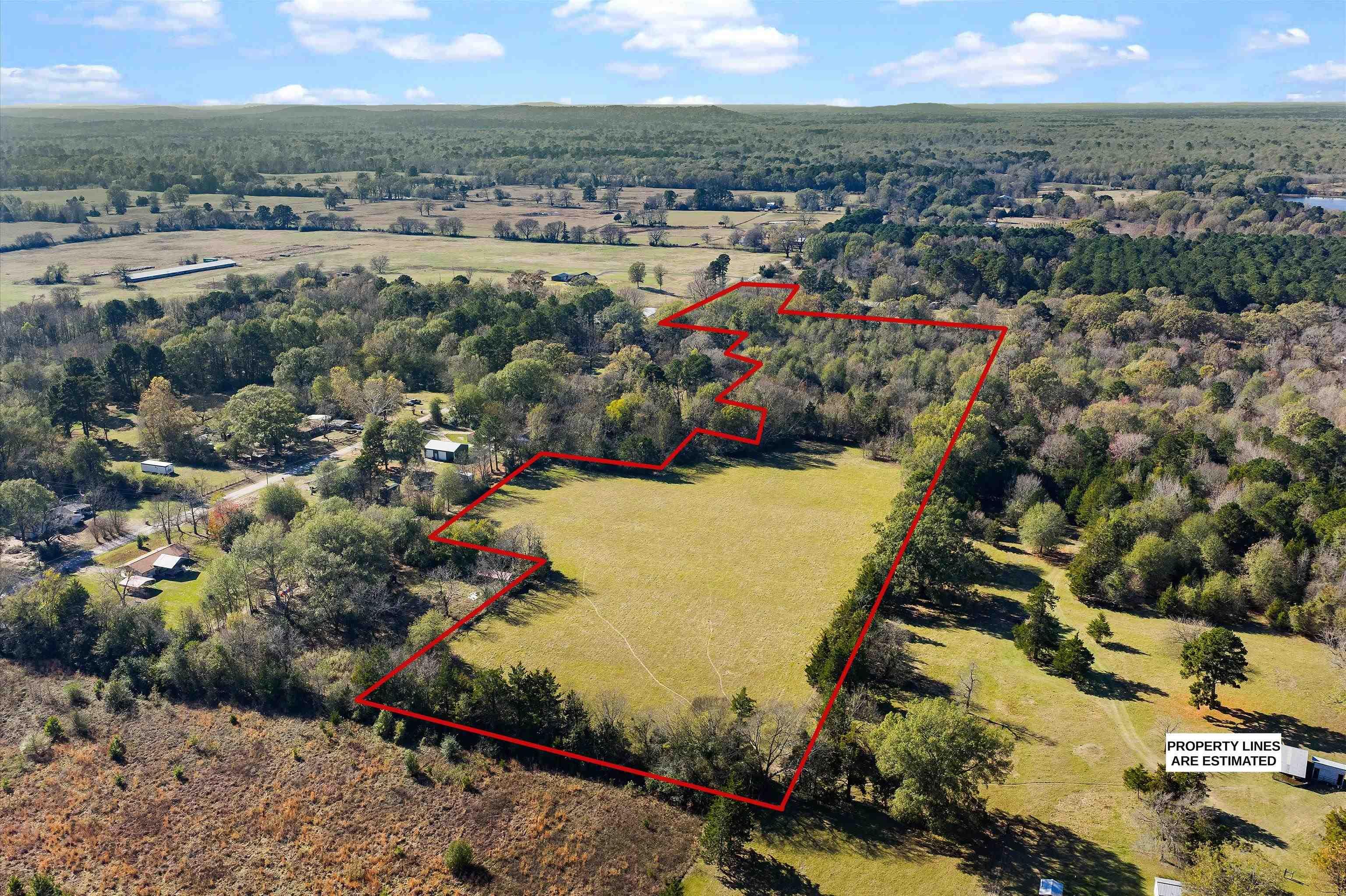 Image 0: View of property location featuring a heavily wooded area and property boundaries highlighted, Aerial View