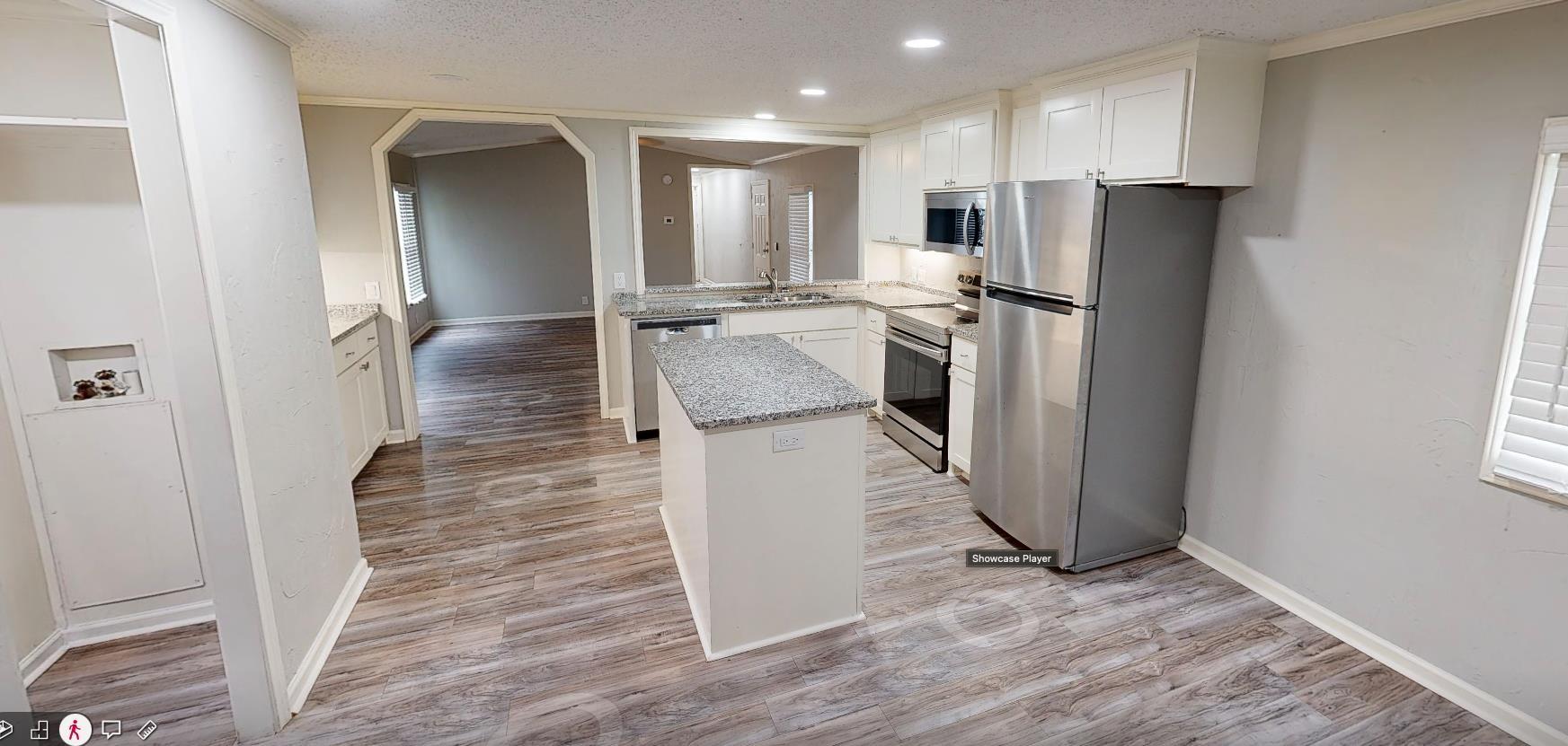 Image 0: Modern kitchen featuring white cabinetry, stainless steel appliances, granite countertops, and wood-finish flooring, Kitchen
