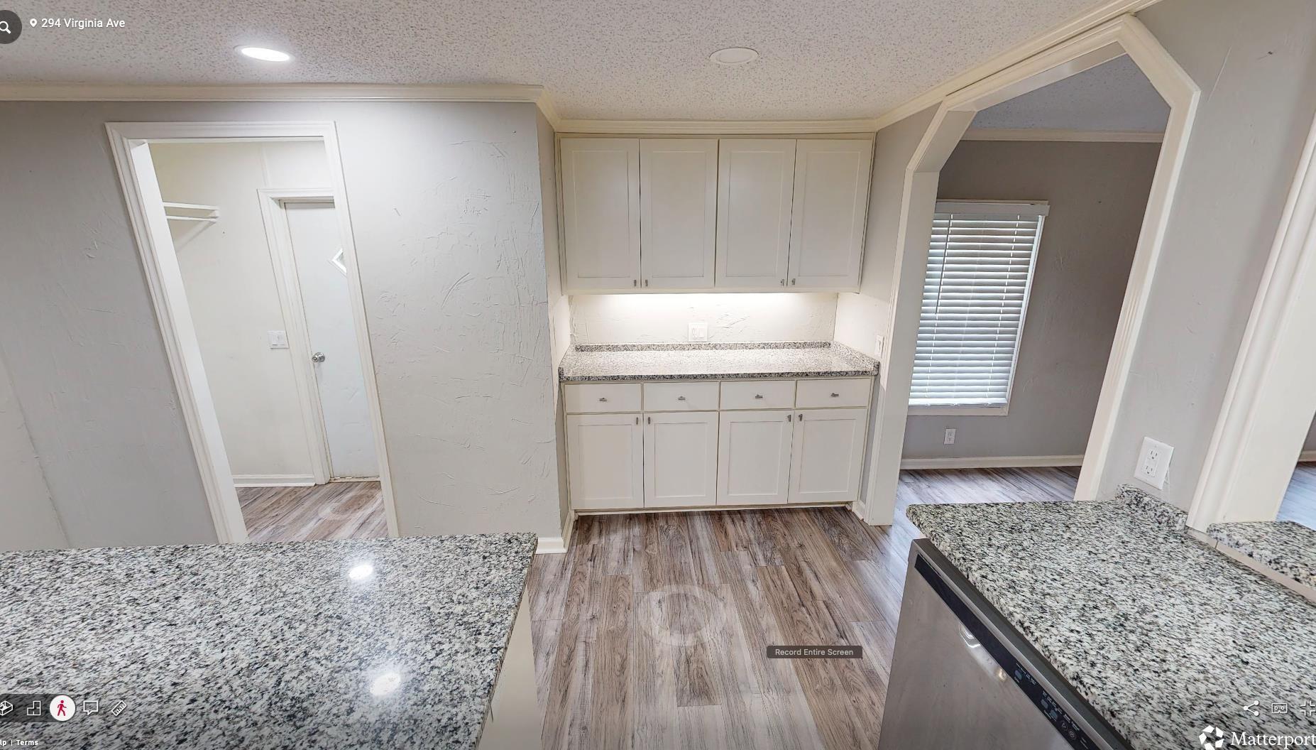 Image 2: Kitchen area featuring white cabinetry, granite-style countertops, wood-finish flooring, and recessed lighting, Kitchen