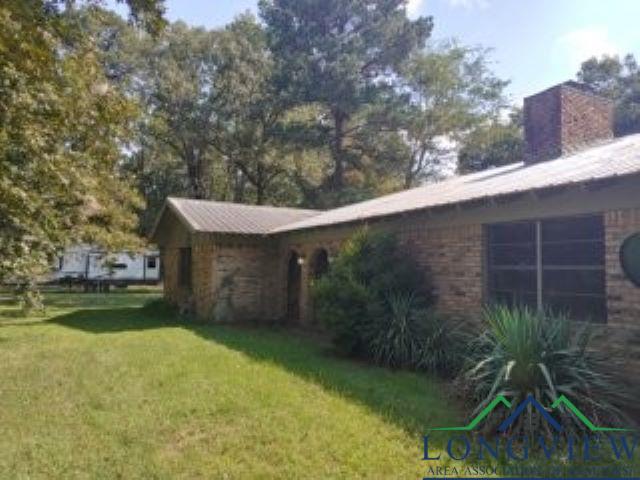 Image 2: High pitch front porch roof design., Other side view of house