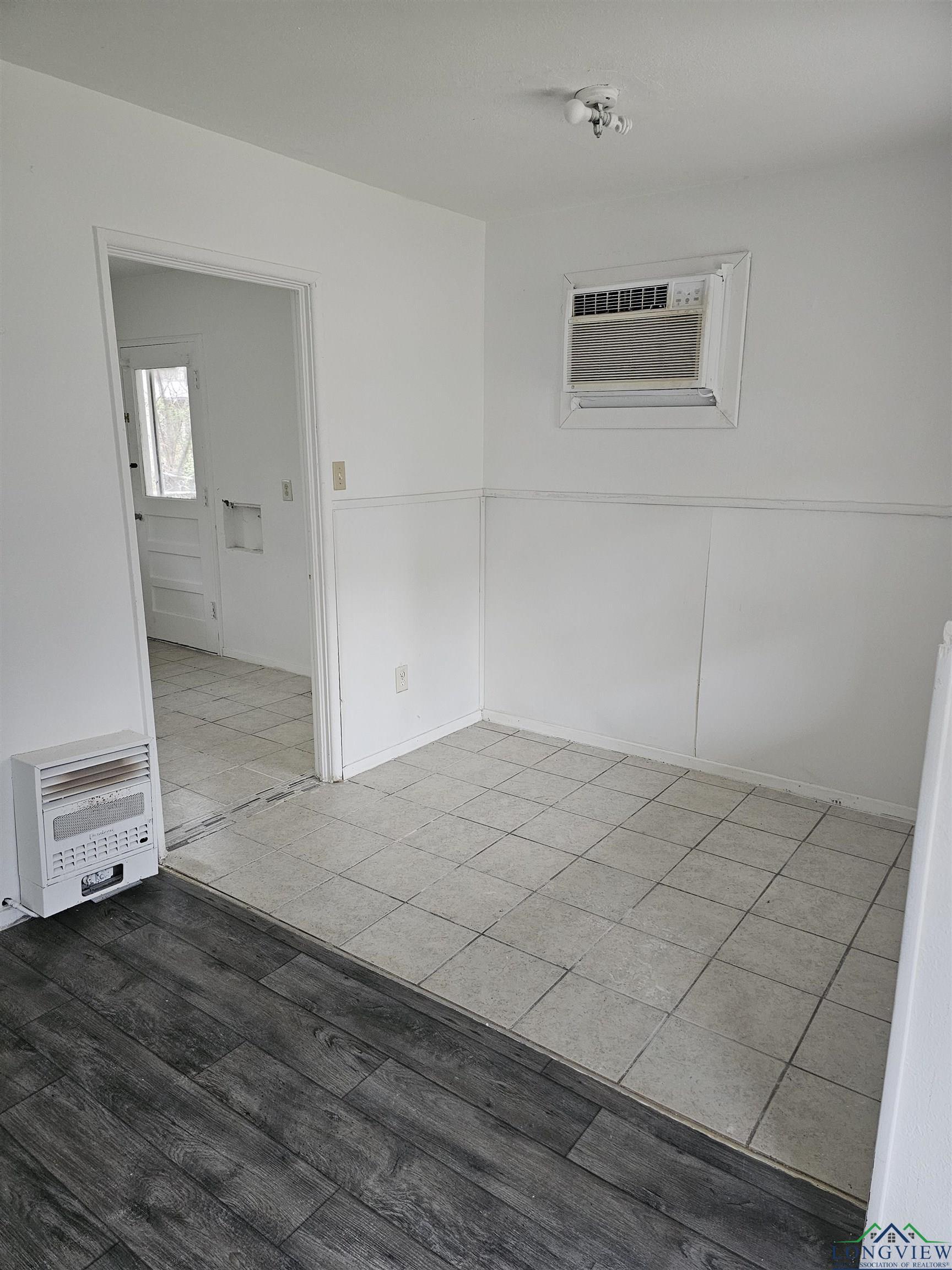 Image 2: Unfurnished room with heating unit, wood finished floors, and a wall mounted AC, Other