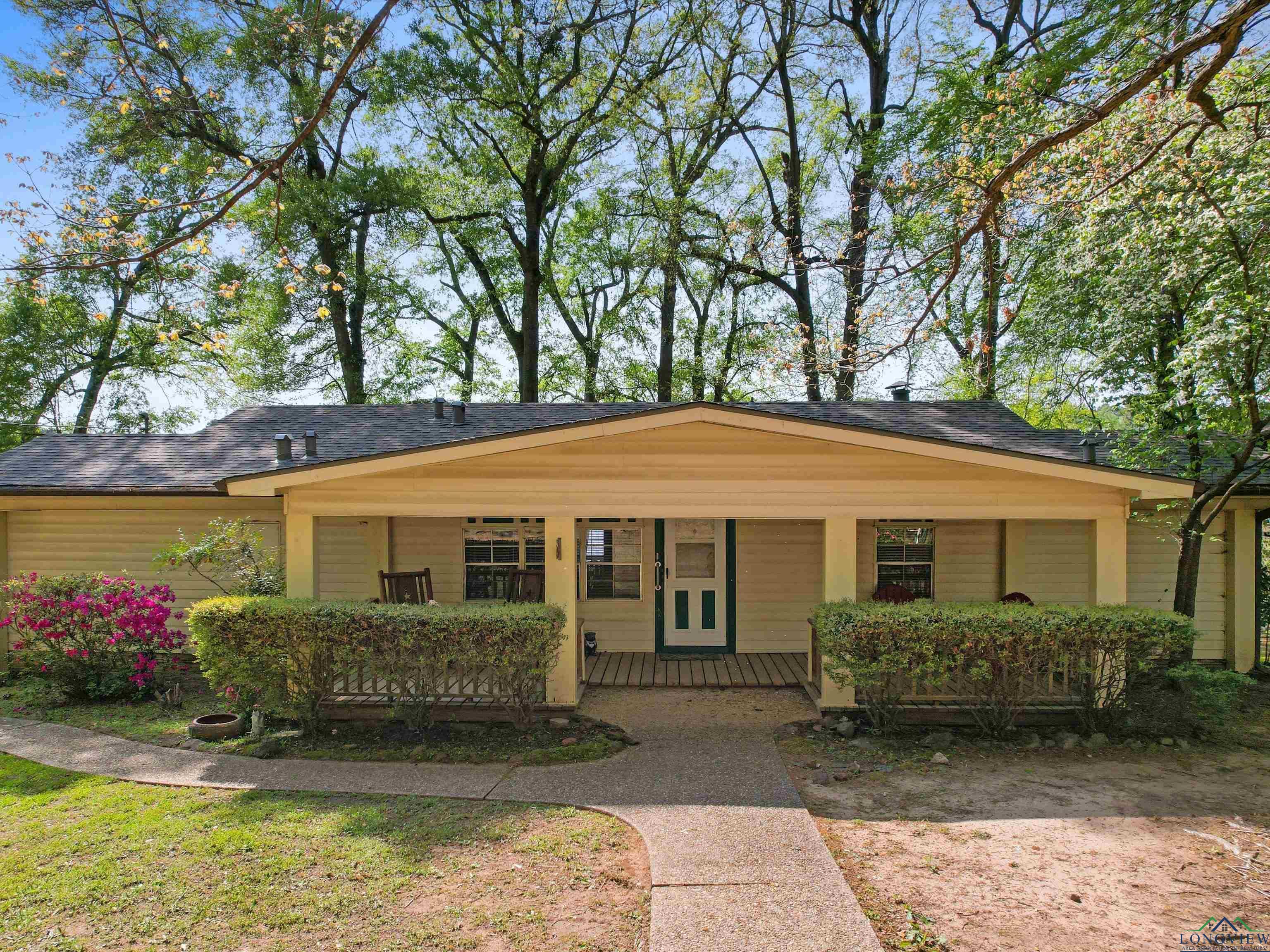 Image 1: View of front of home with a porch and a shingled roof, Front Of Structure