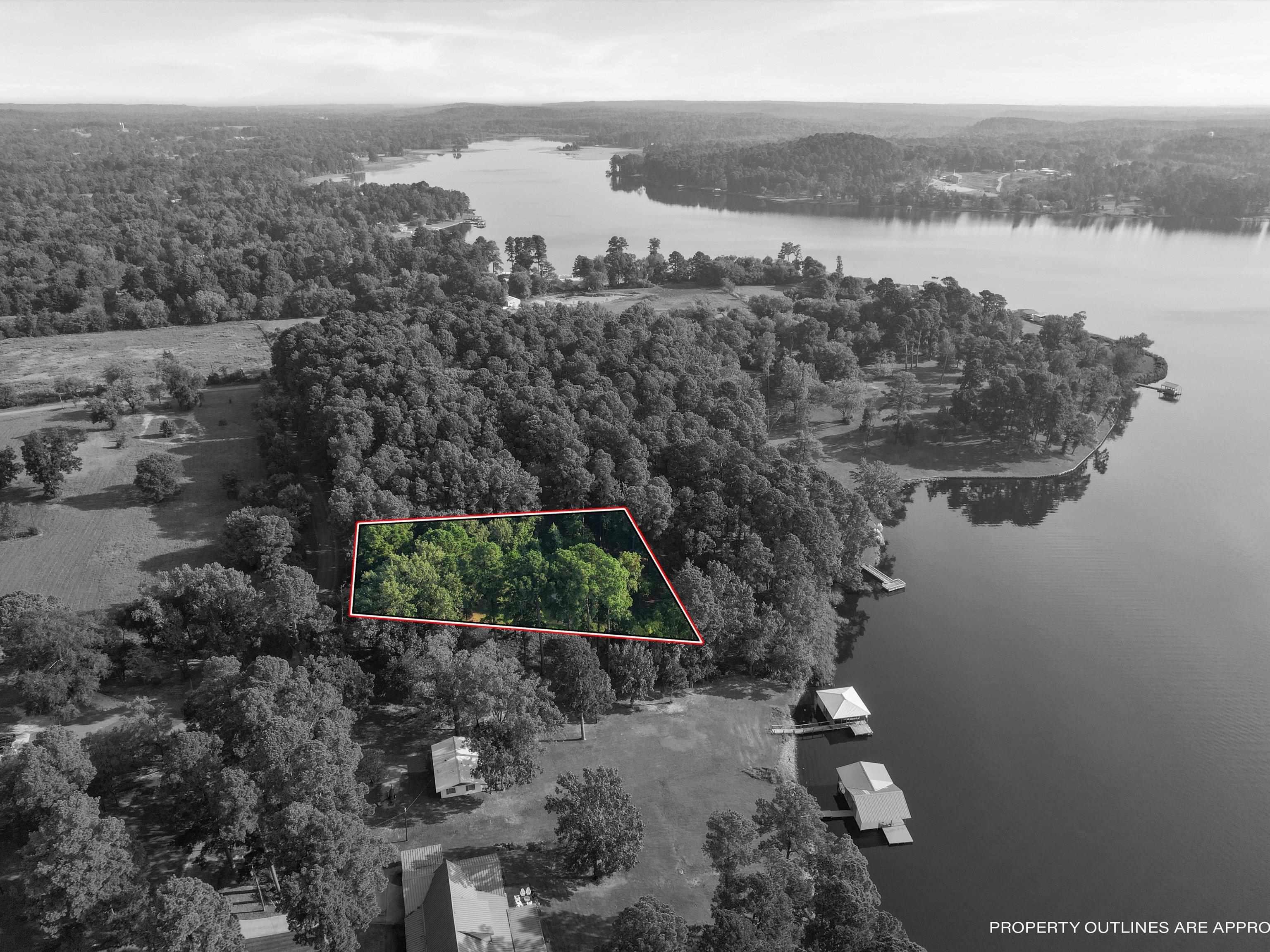 Image 1: Aerial overview of property's location with a large body of water and property boundaries highlighted, Aerial View