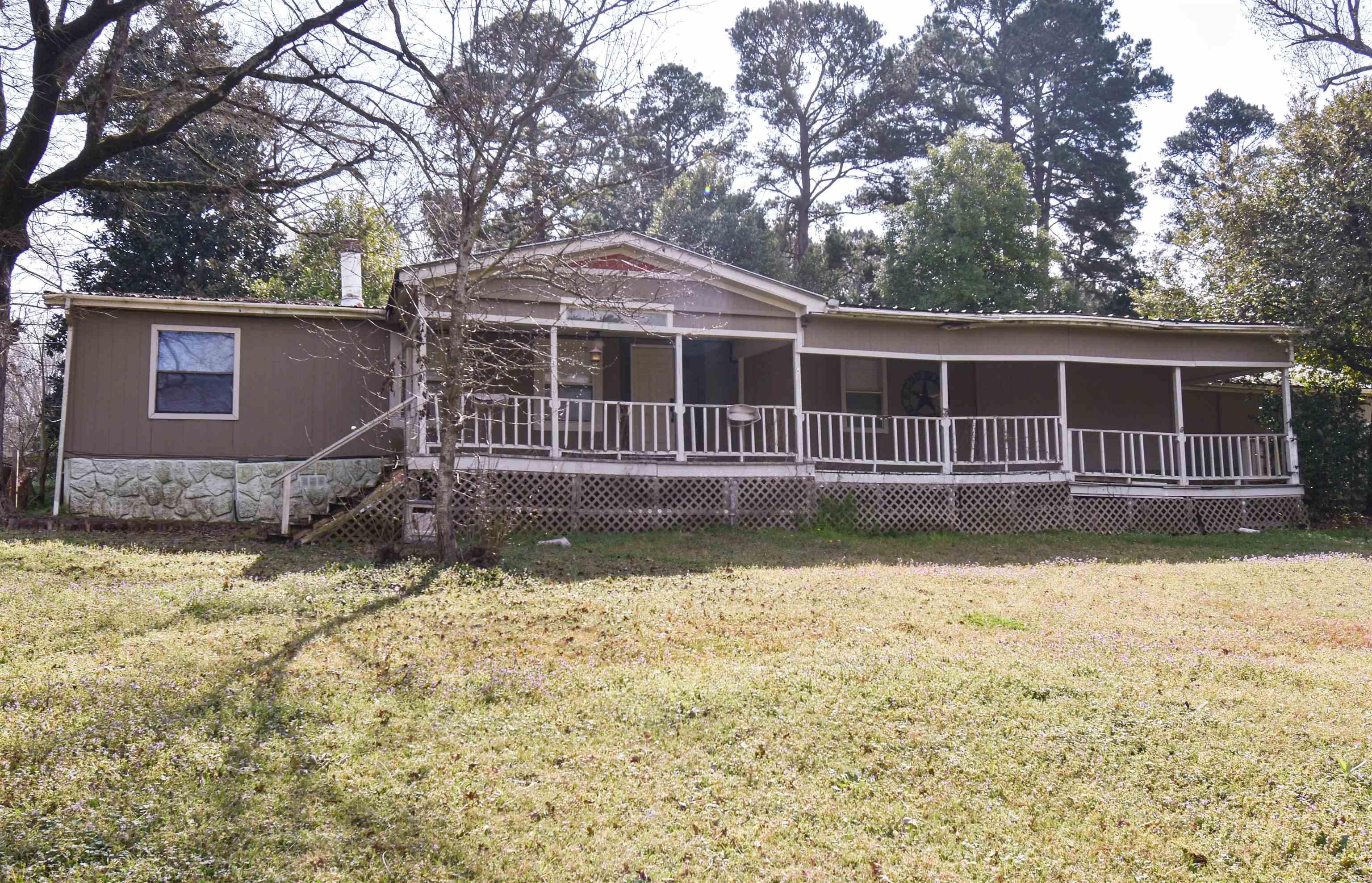 Image 0: View of front of home featuring a porch and a front yard, Front Of Structure