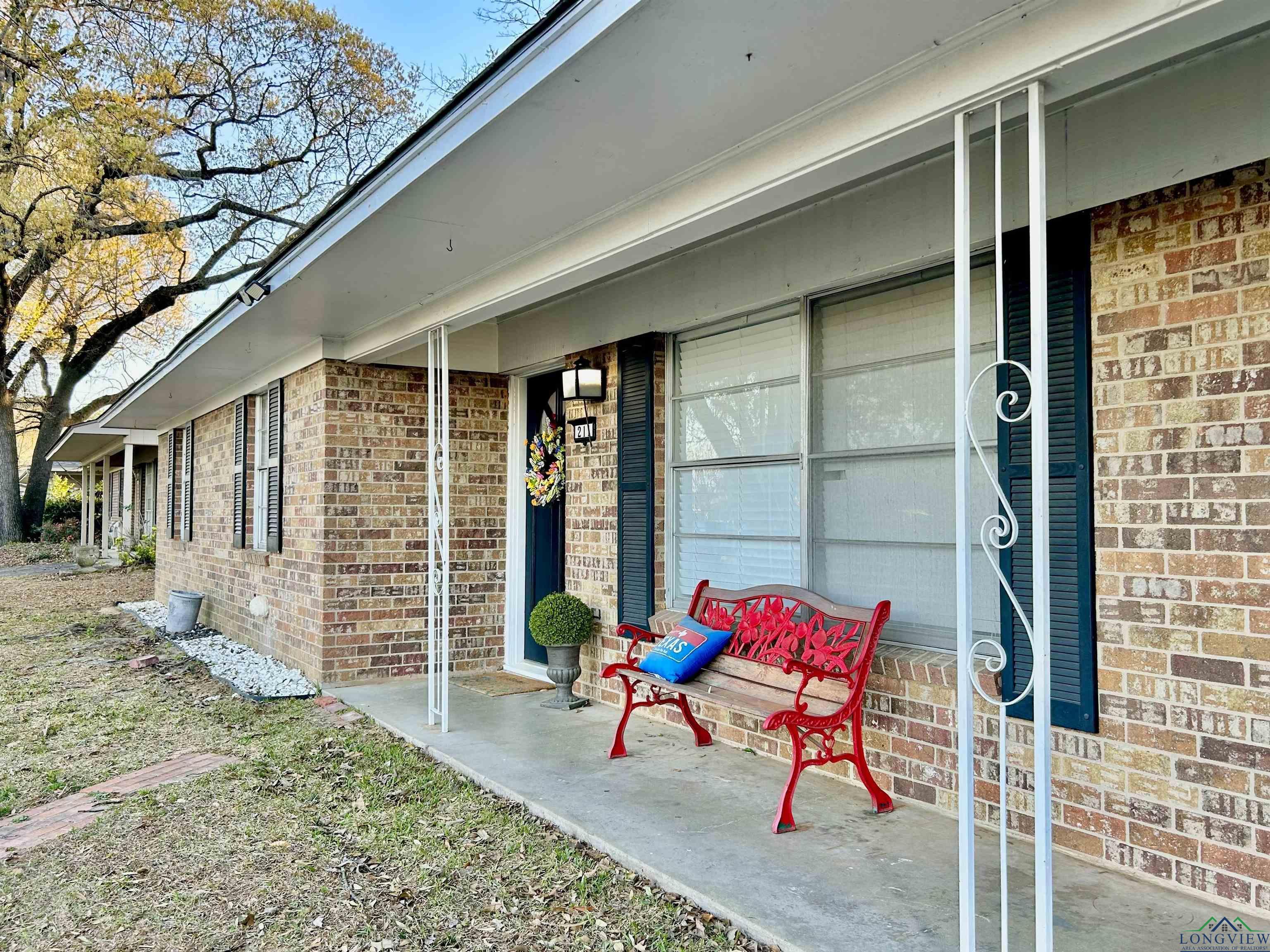 Image 0: Property entrance featuring brick siding and a porch, Entry
