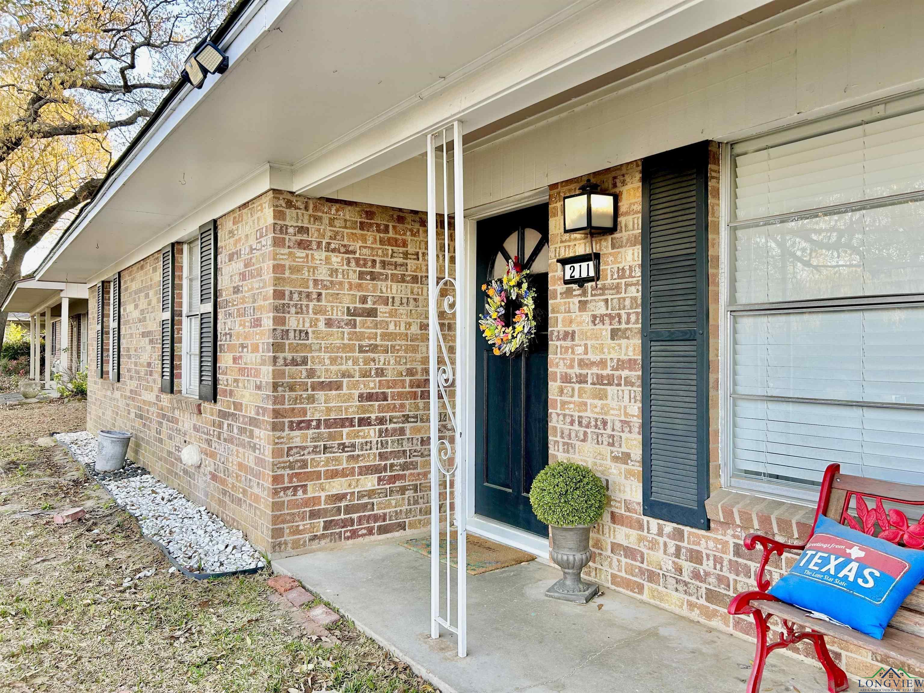 Image 1: Property entrance with brick siding and covered porch, Entry