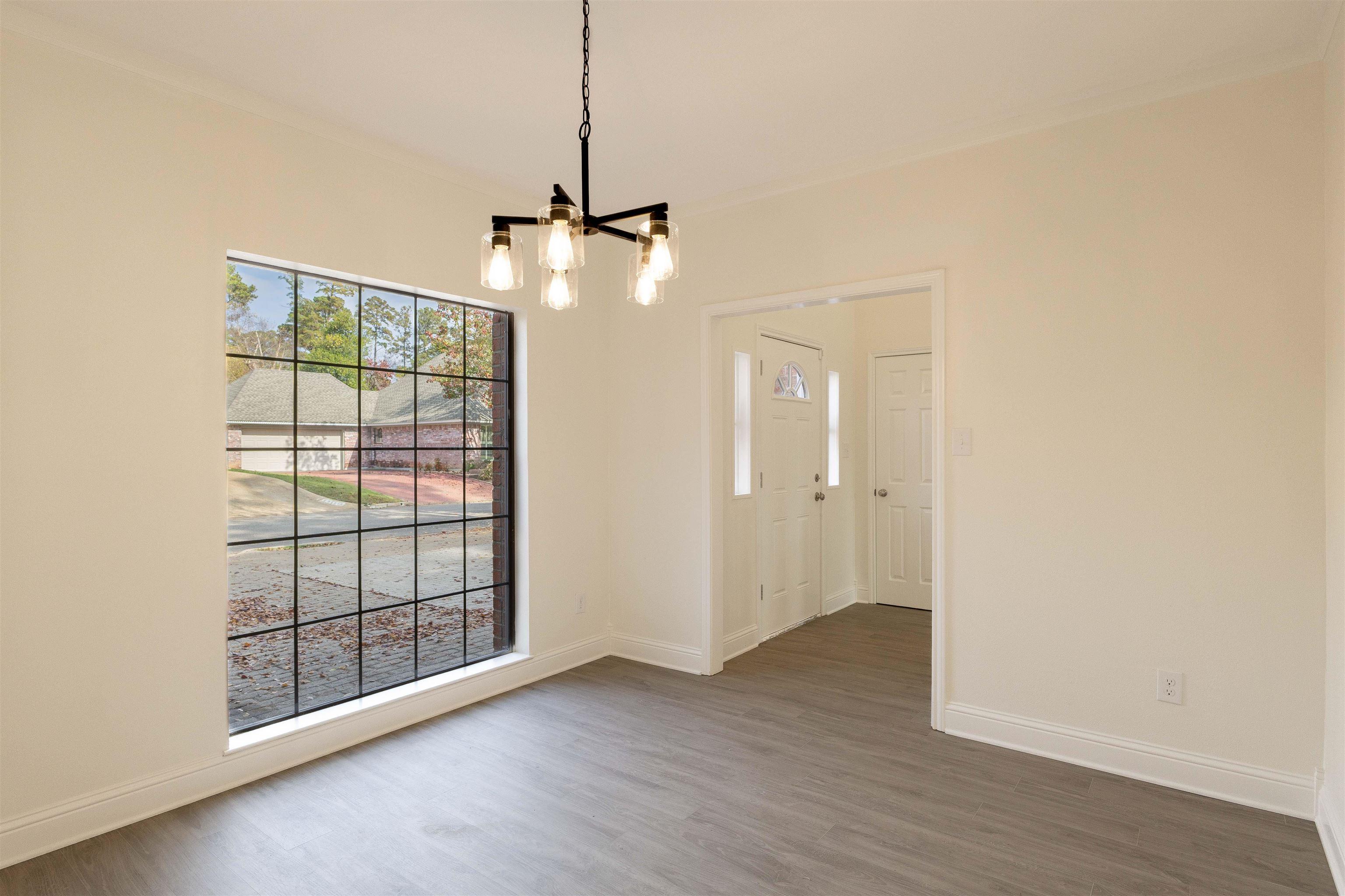 Image 3: Unfurnished dining area featuring a chandelier and wood finished floors, Dining Area