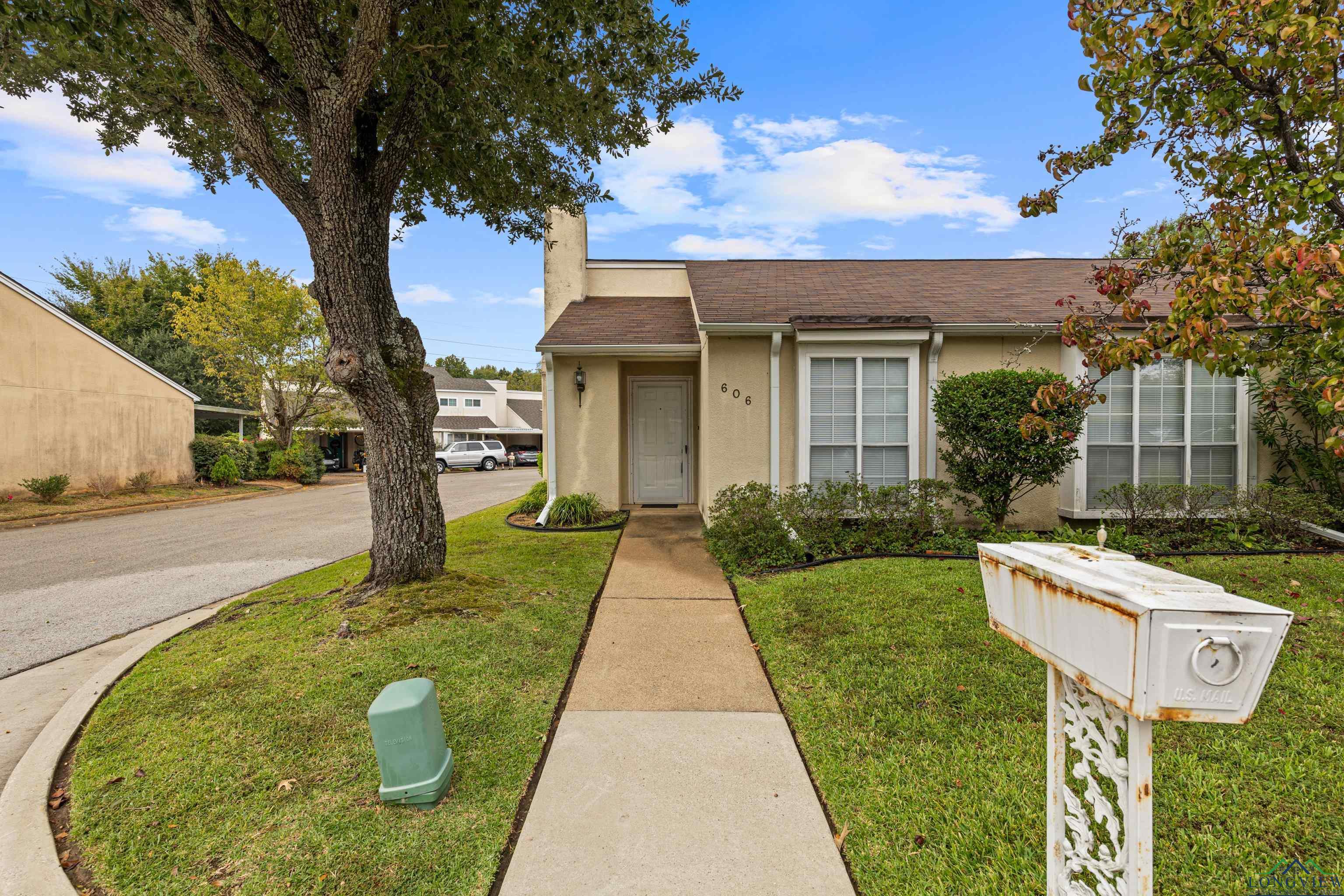 Image 3: View of front of home featuring stucco siding, a front yard, a shingled roof, and a chimney, Front Of Structure