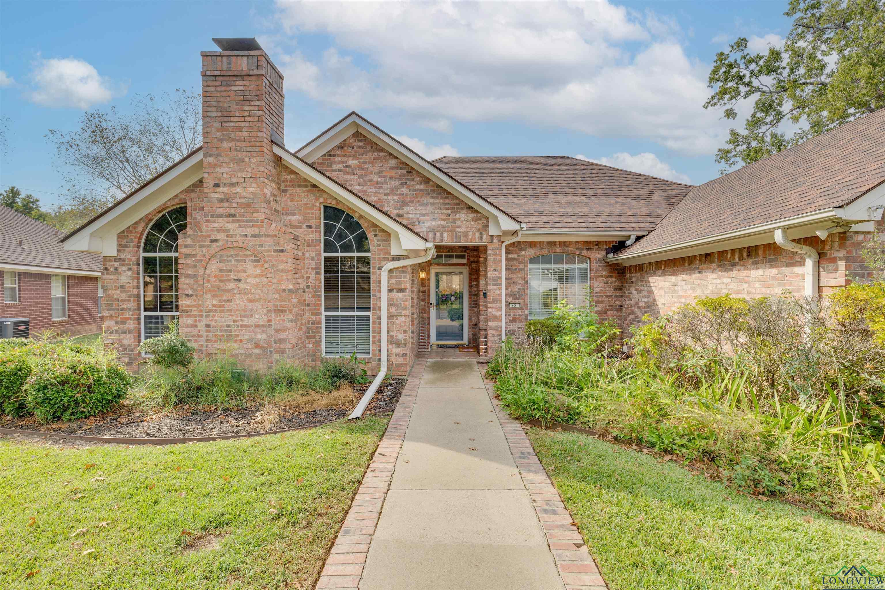 Image 0: View of front of home featuring brick siding, roof with shingles, a front yard, and a chimney, Front Of Structure