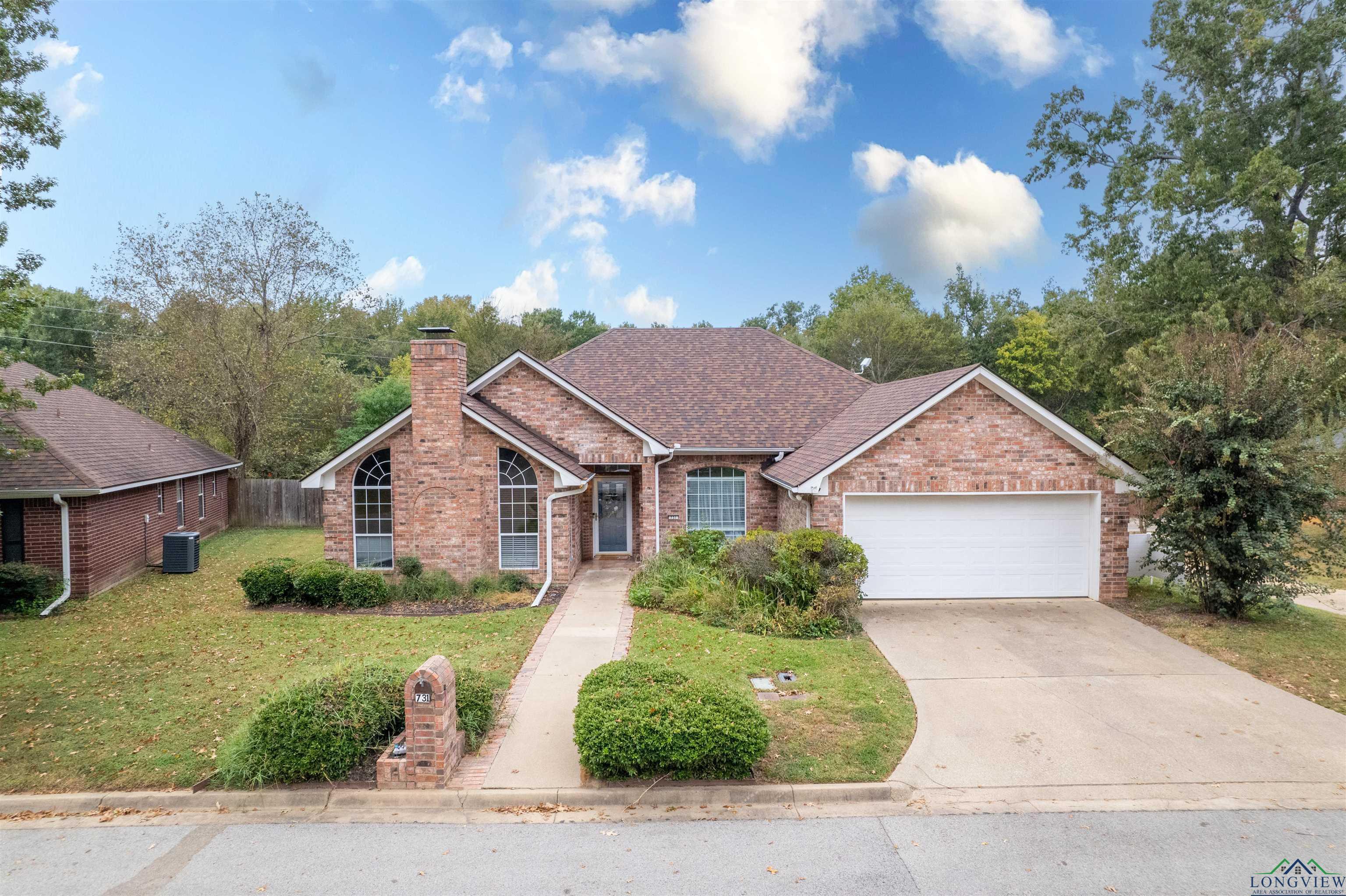 Image 2: Single story home with brick siding, driveway, a chimney, an attached garage, and a shingled roof, Front Of Structure