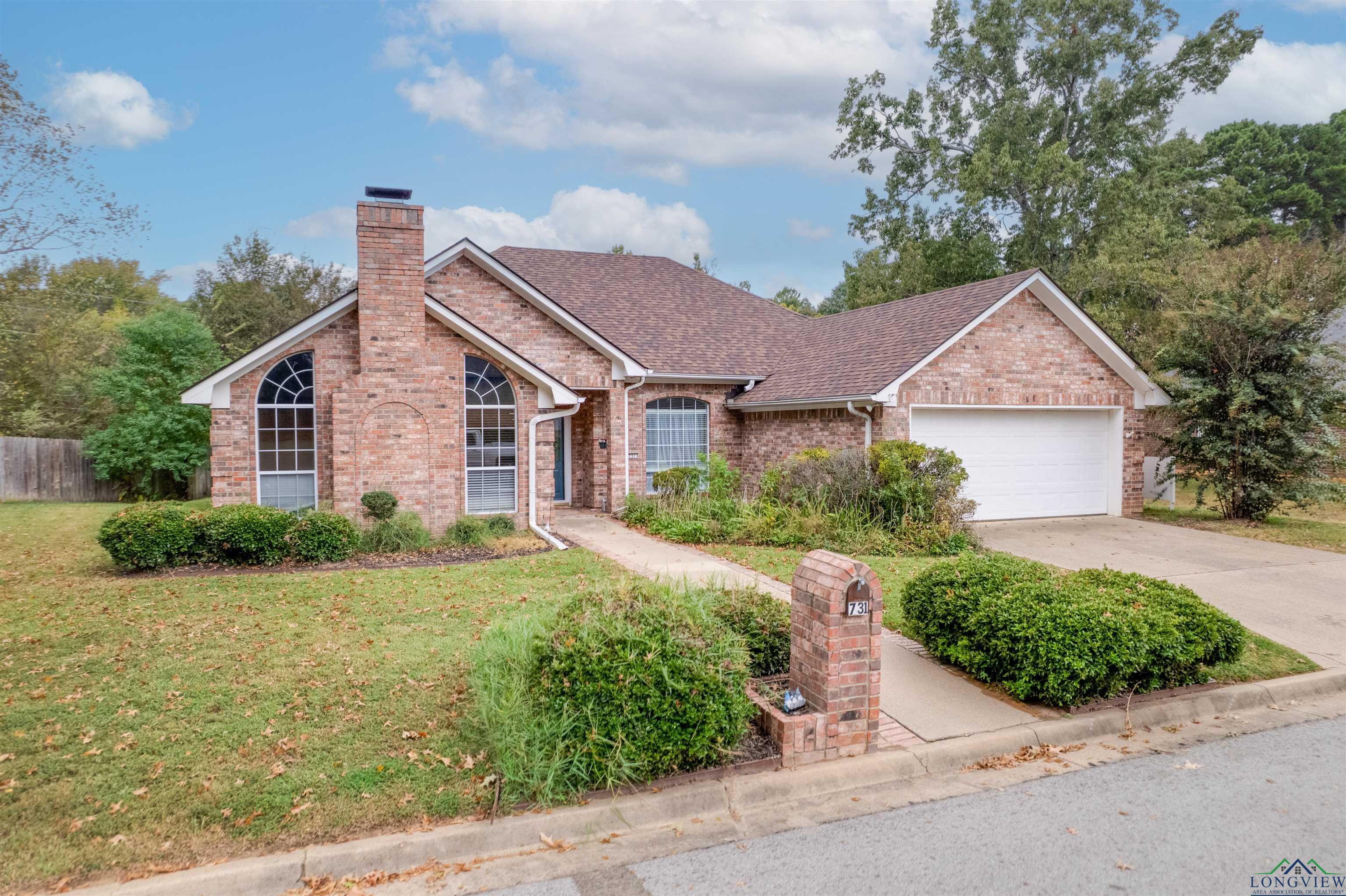 Image 3: Ranch-style home featuring brick siding, concrete driveway, a shingled roof, an attached garage, and a chimney, Front Of Structure
