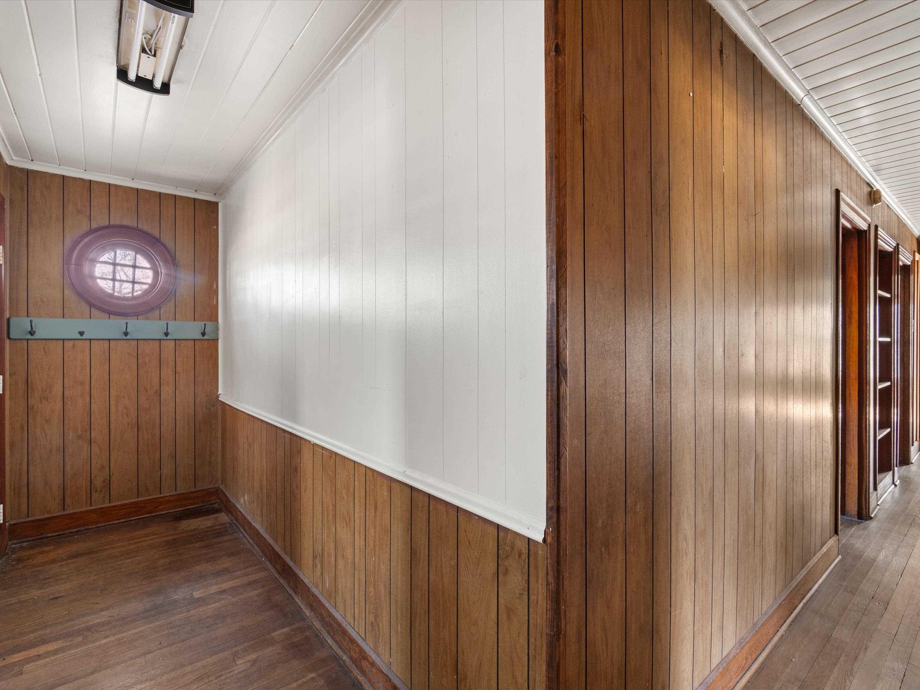 Image 2: Hallway with wood walls and dark wood-type flooring, Hallway