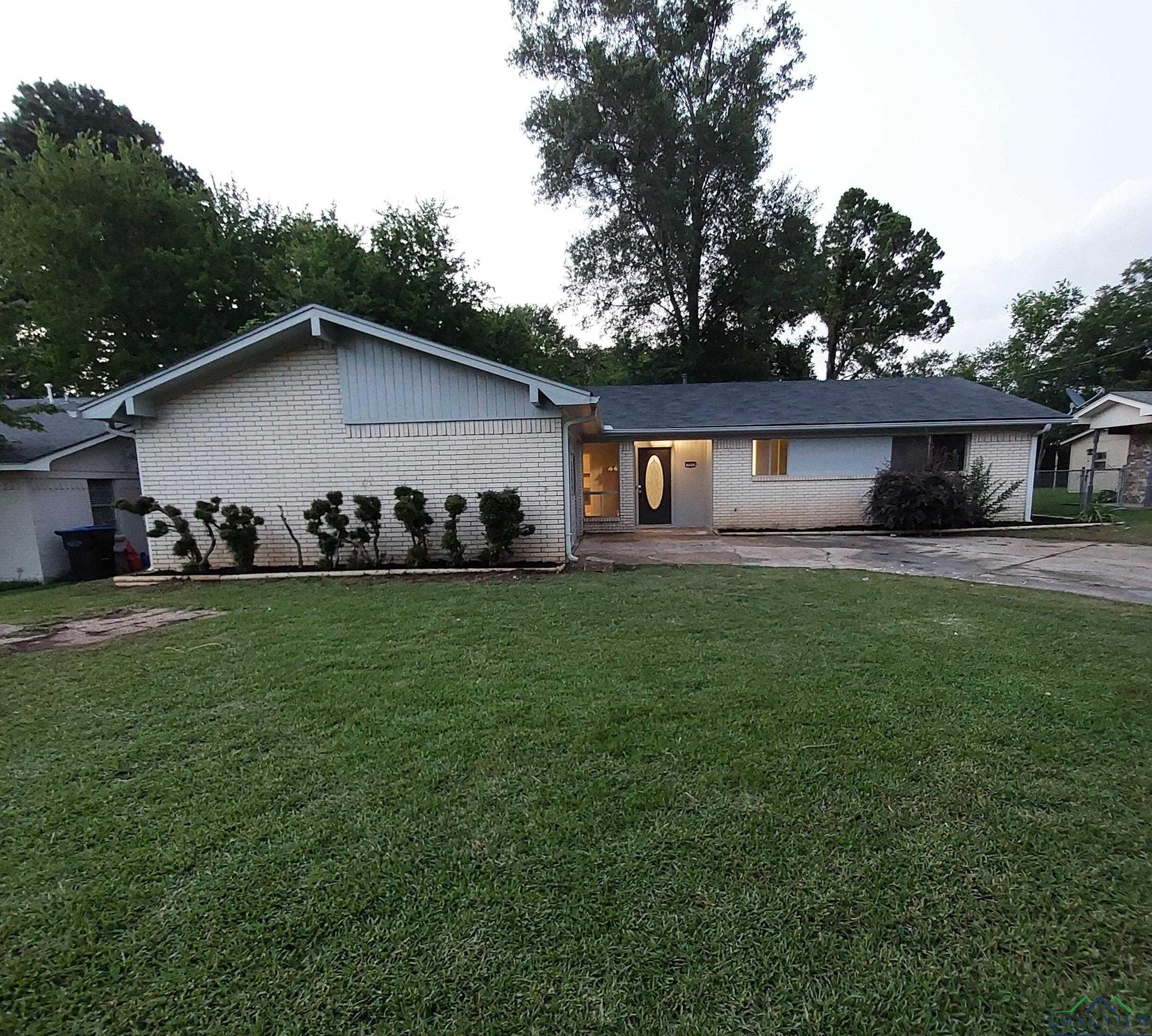 Image 0: View of front of property with brick siding and a front lawn, Front Of Structure