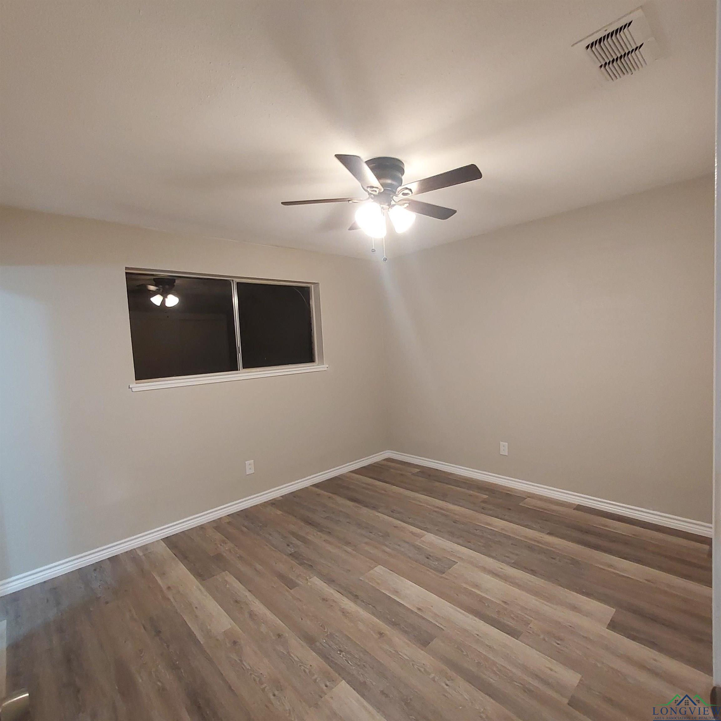 Image 1: Empty room with ceiling fan and wood finished floors, Other