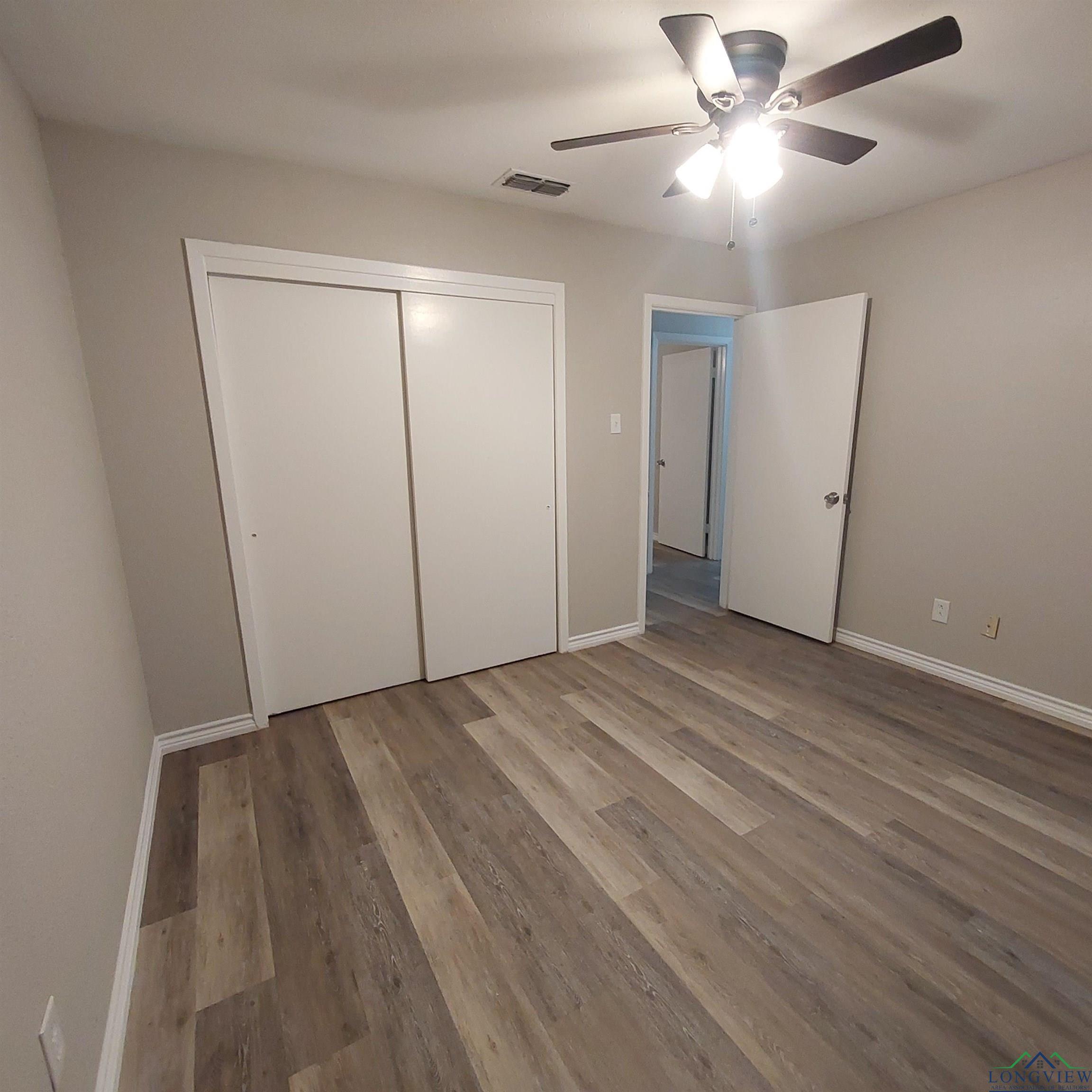 Image 2: Unfurnished bedroom featuring wood finished floors, a closet, and ceiling fan, Bedroom