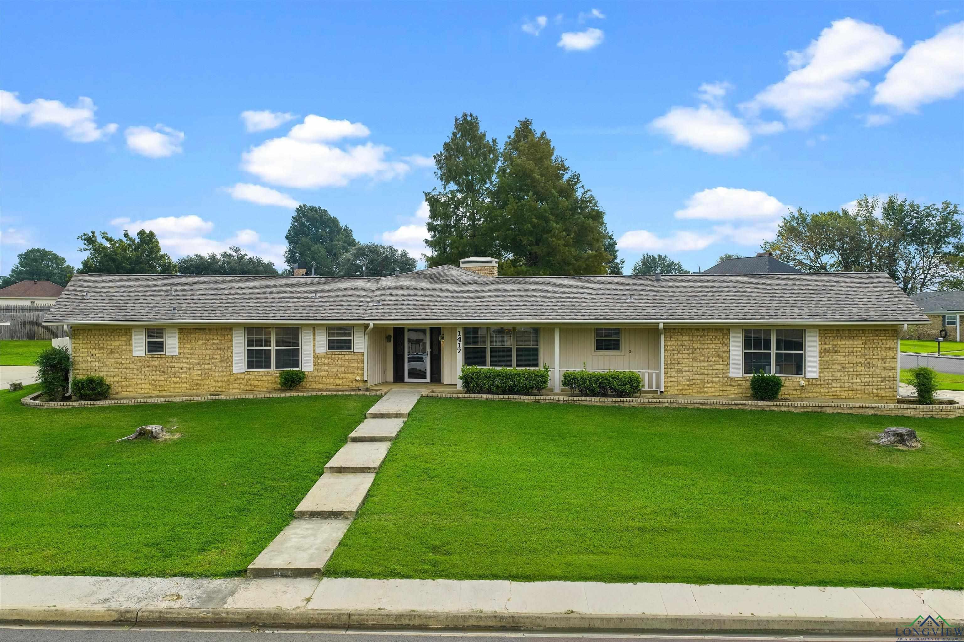 Image 1: Ranch-style house with a front lawn, brick siding, roof with shingles, a chimney, and a porch, Front Of Structure
