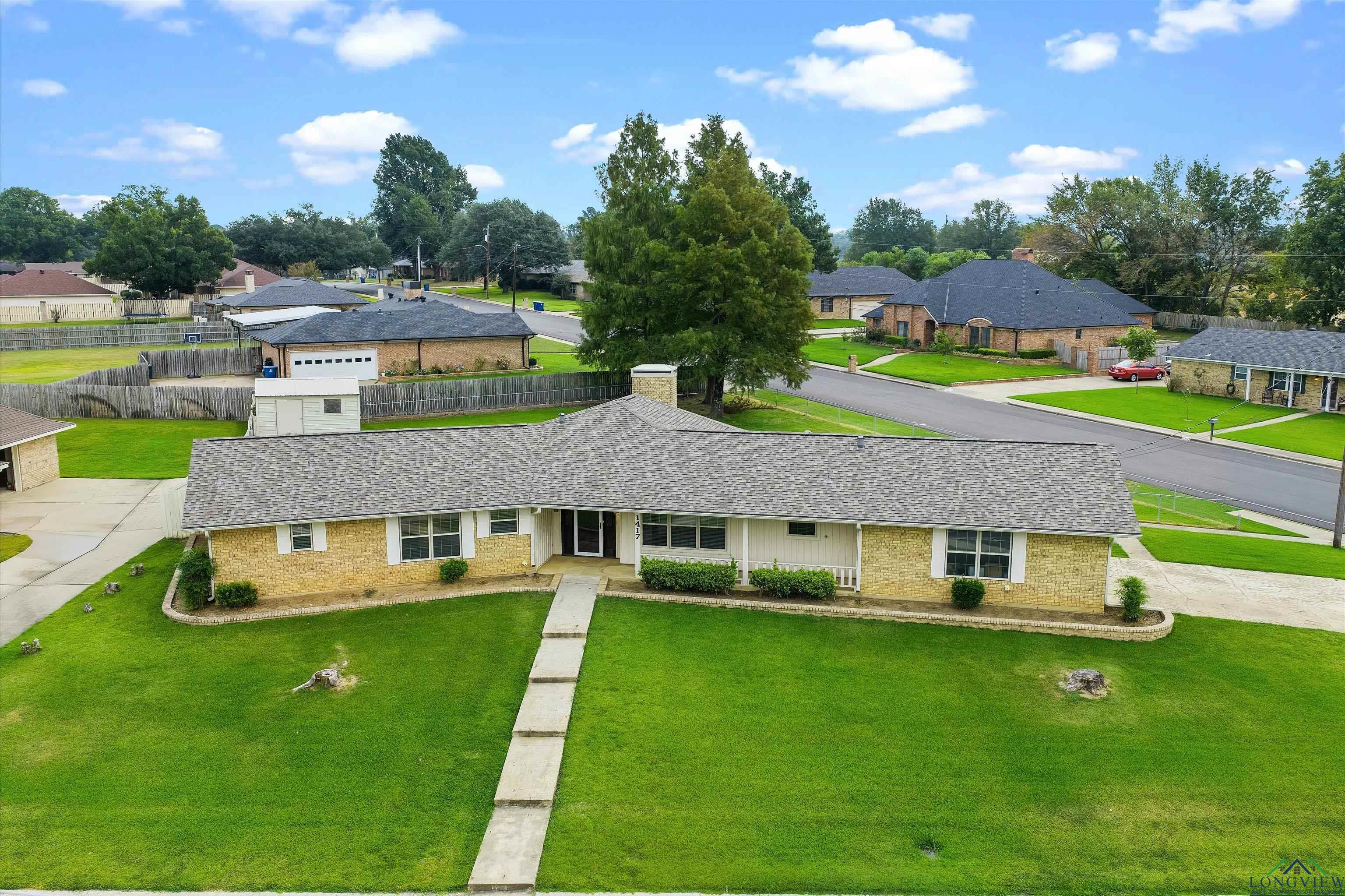Image 2: View of front of property featuring brick siding, a residential view, a shingled roof, a chimney, and driveway, Front Of Structure