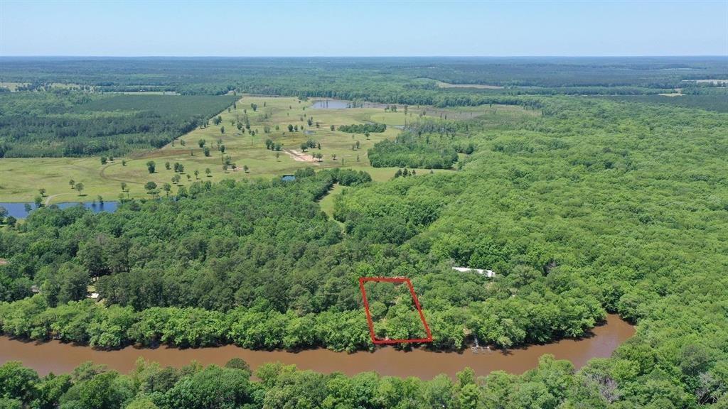 Image 2: View of rural area with property parcel outlined and a nearby body of water, Aerial View