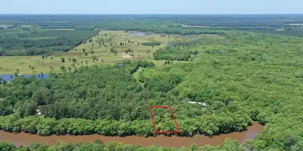 Image 2: View of rural area with property parcel outlined and a nearby body of water, Aerial View