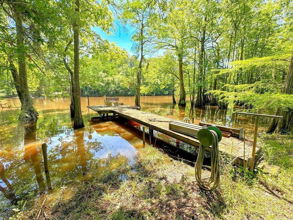 Image 3: View of home's community featuring a water view and a boat dock, Community