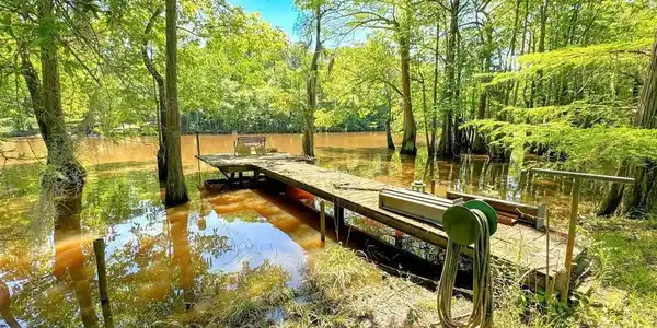 Image 3: View of home's community featuring a water view and a boat dock, Community