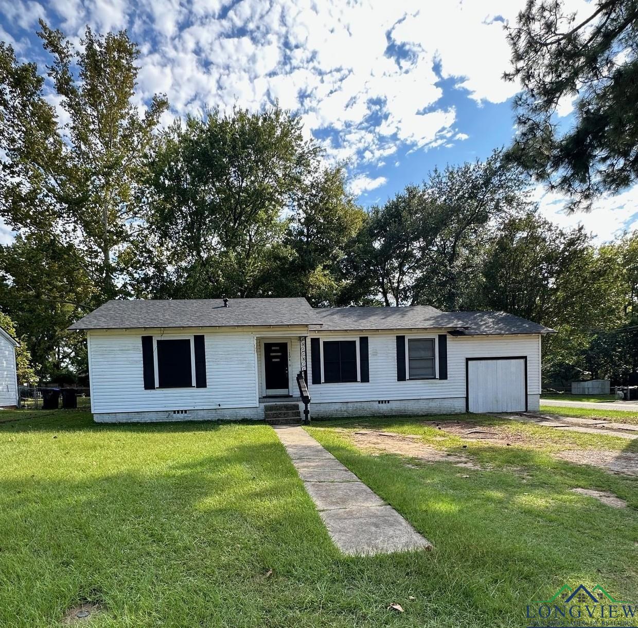 Image 0: Ranch-style home featuring a front lawn, driveway, and a garage, Front Of Structure