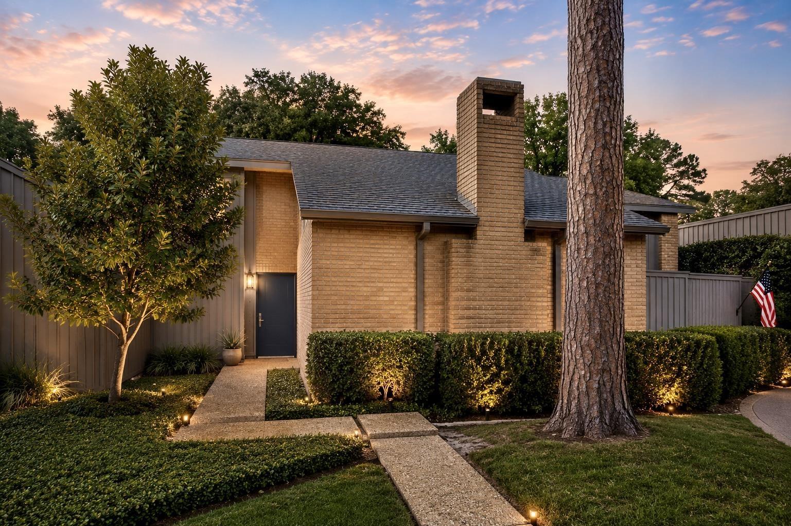 Image 1: Brick facade residence featuring a prominent chimney structure, Front Of Structure