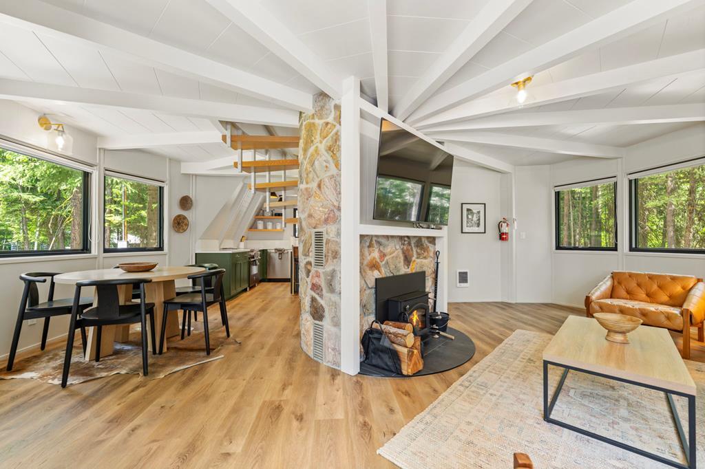 Image 3: Great Room, Newly remodeled, the great room is open with plenty of natural light and centered around the stone fireplace.