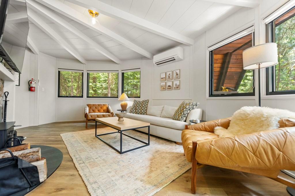 Image 4: Living Room, A comfortable gathering area centered around the fireplace.