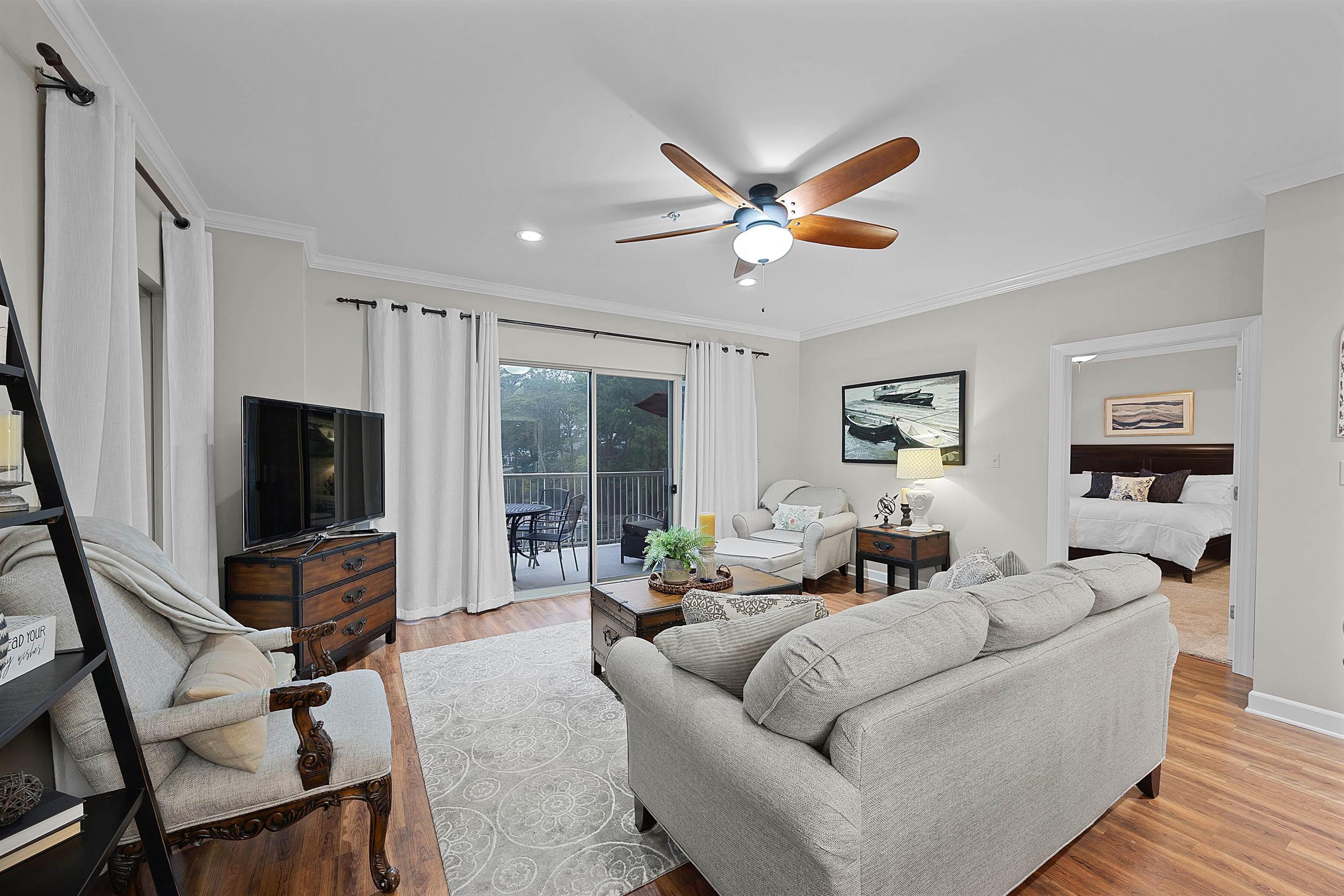 Image 3: Living area featuring a ceiling fan, light wood-style flooring, recessed lighting, and crown molding