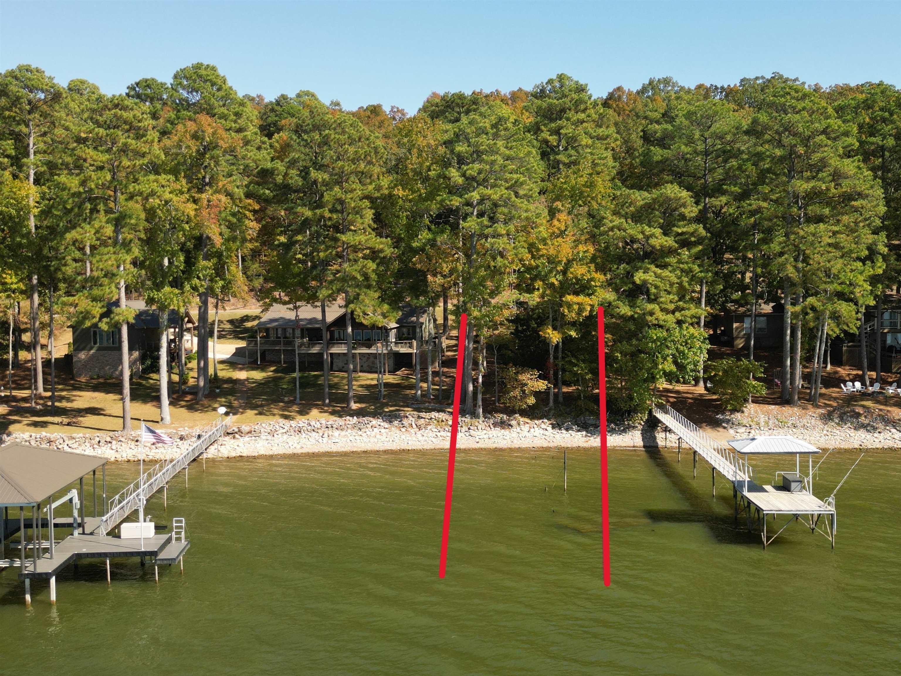 Image 2: Dock area featuring boat lift and a water view