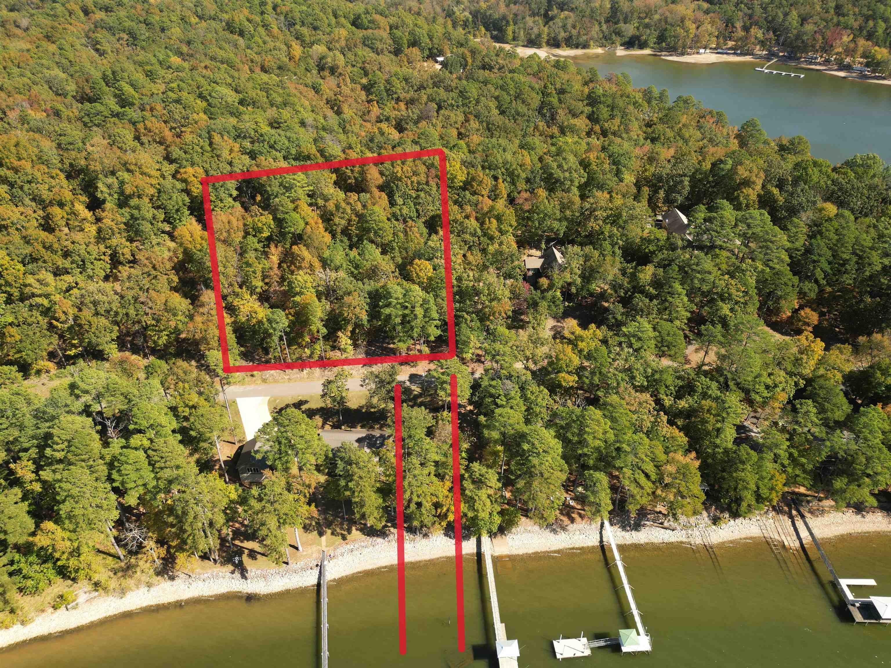 Image 4: Aerial overview of property's location with a nearby body of water and property parcel outlined
