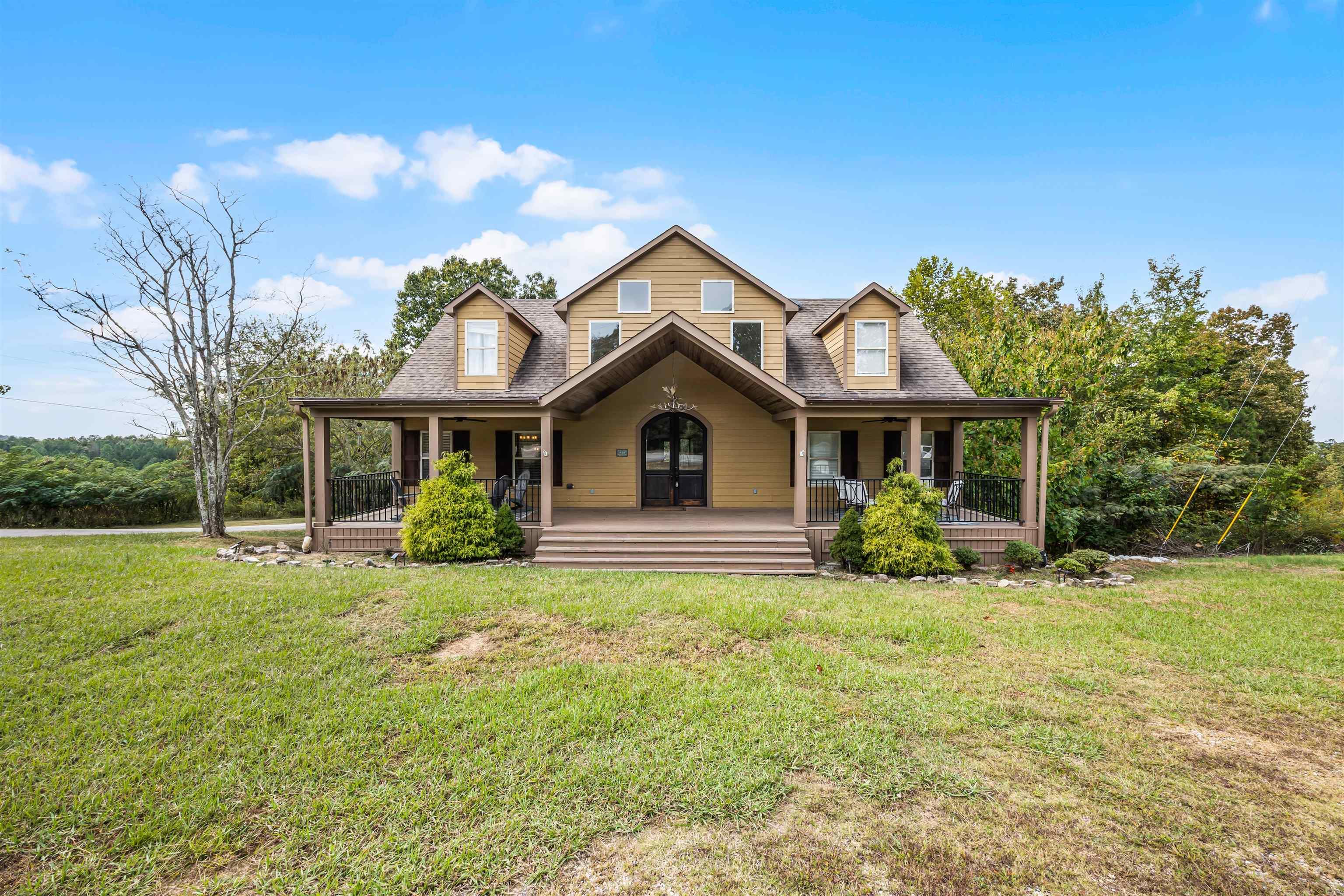 Image 3: View of front of house featuring a porch, a front yard, and roof with shingles