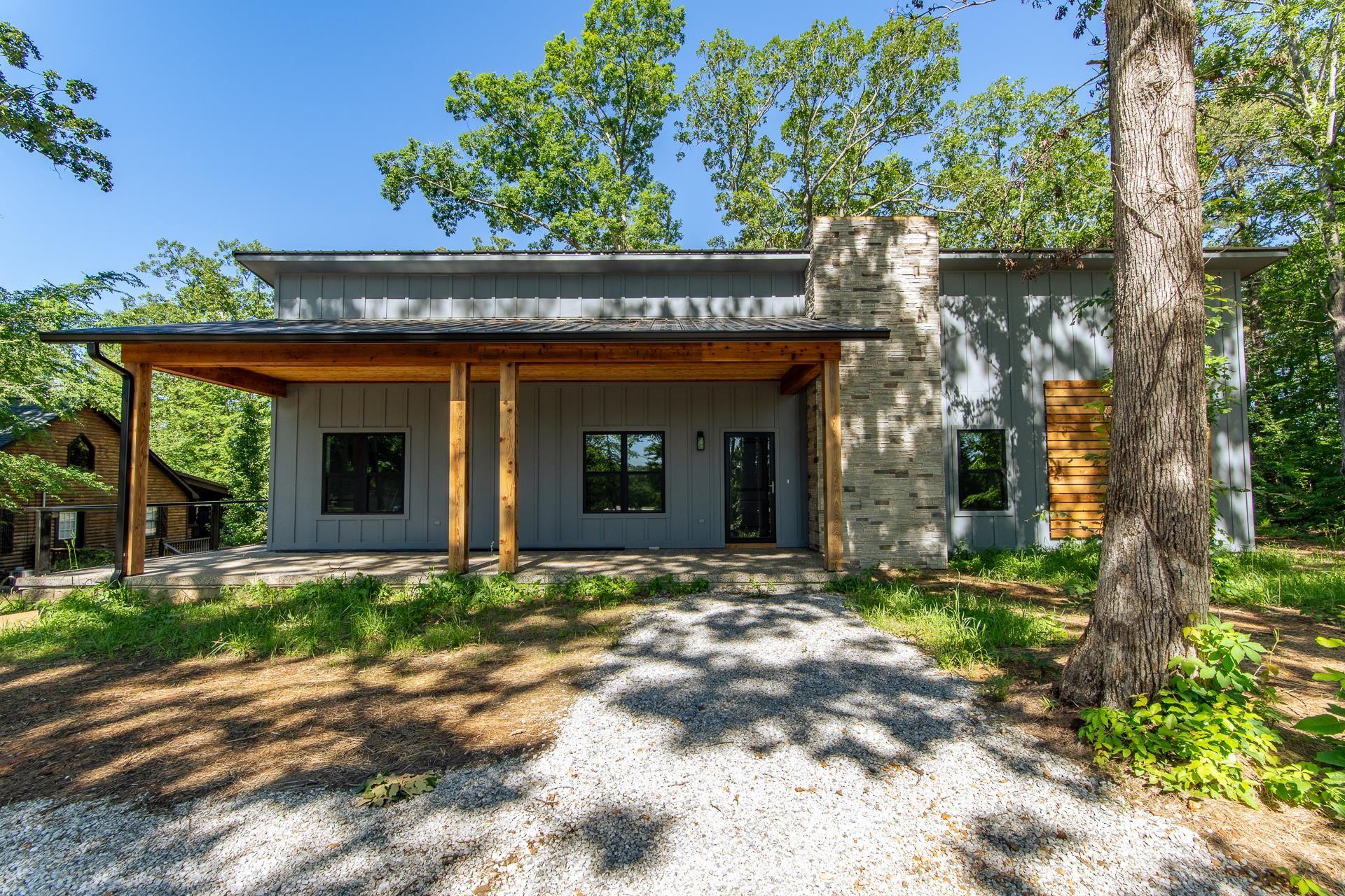 Image 2: Contemporary house featuring a patio and board and batten siding