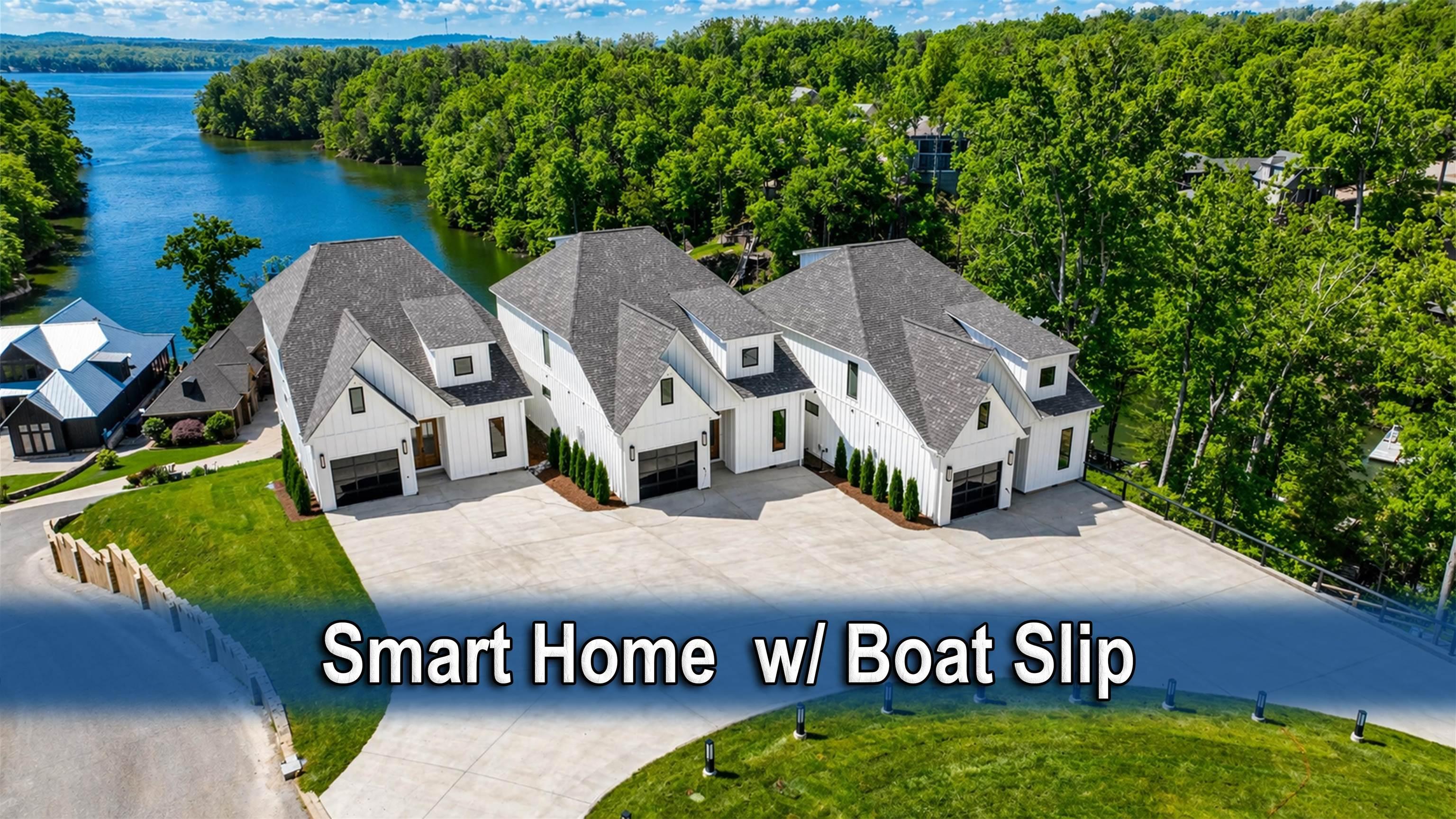 Image 1: Modern waterfront residences featuring white vertical siding, black garage doors, gray shingle roofs, and lush surrounding trees